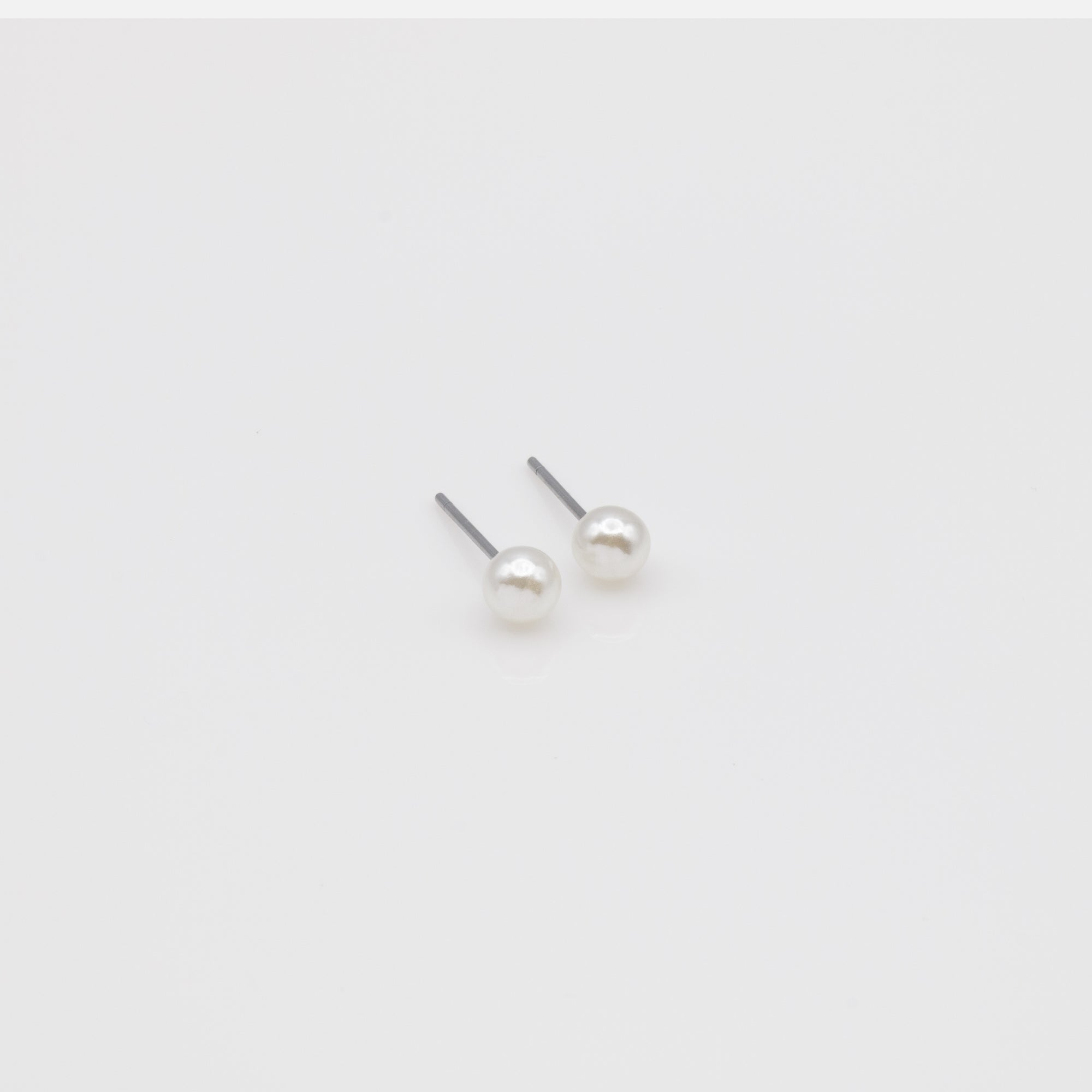 Trio of white butterfly earrings and gold rings
