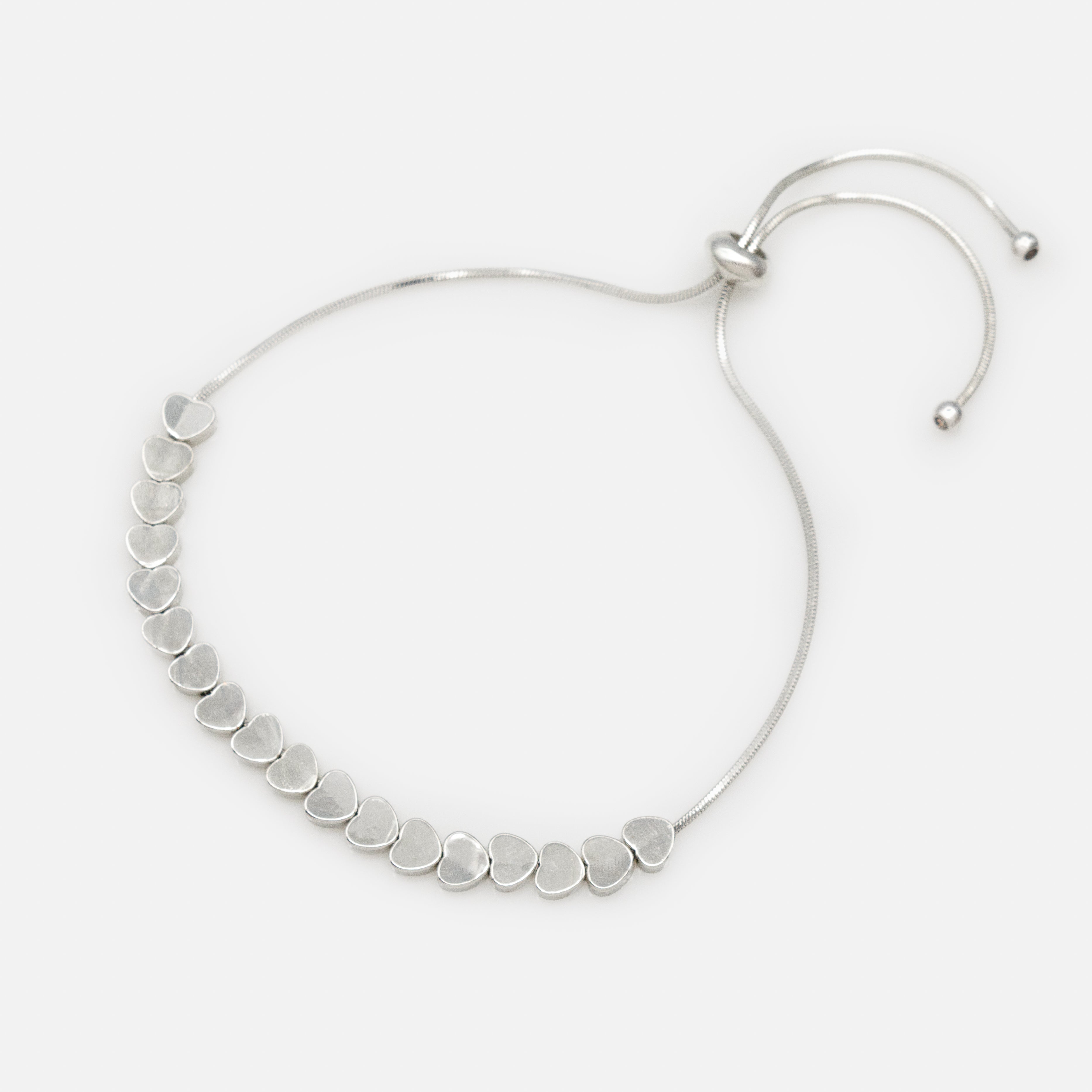 Adjustable silver bracelet with a series of flat hearts