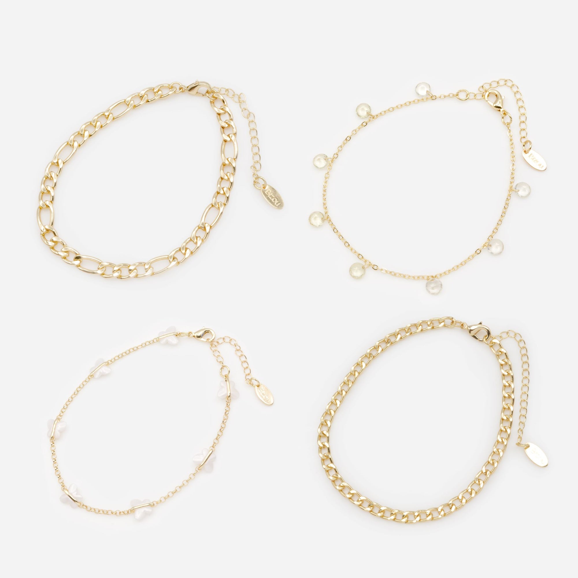 Set of four gold anklets with white butterflies