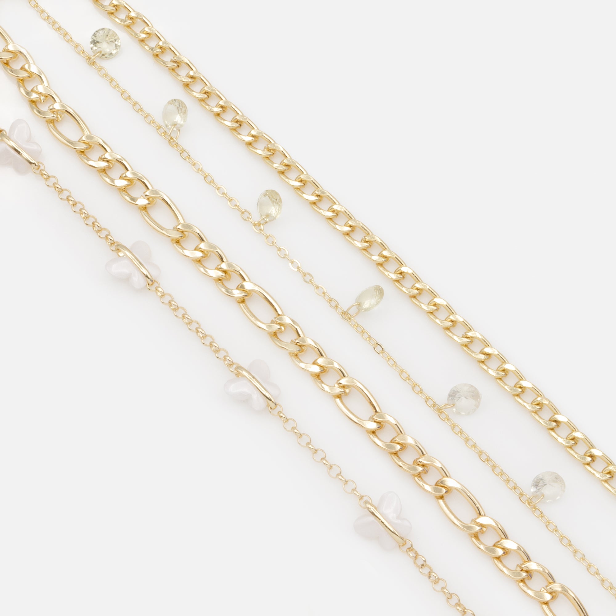 Set of four gold anklets with white butterflies