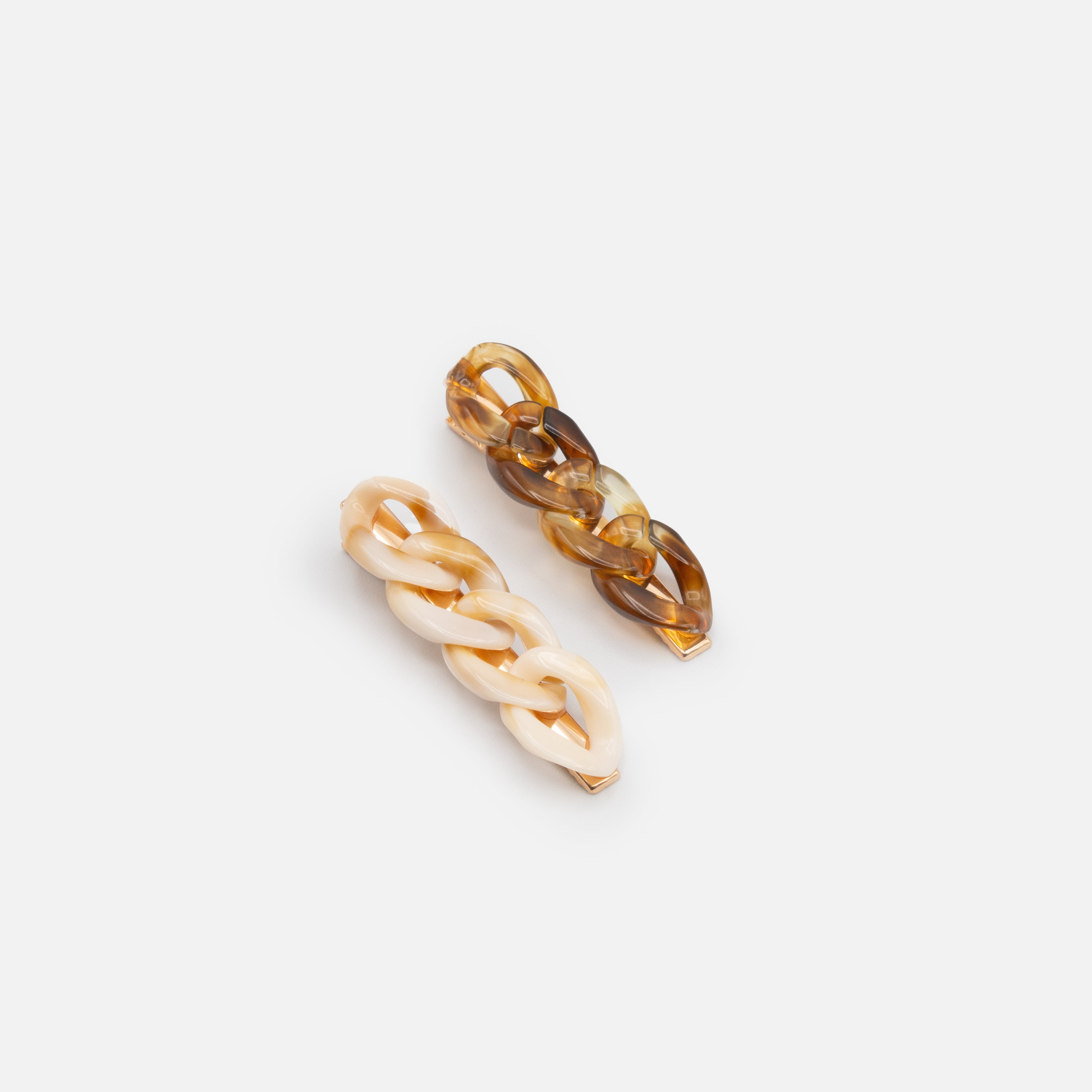 Duo of ivory and tortoise clips