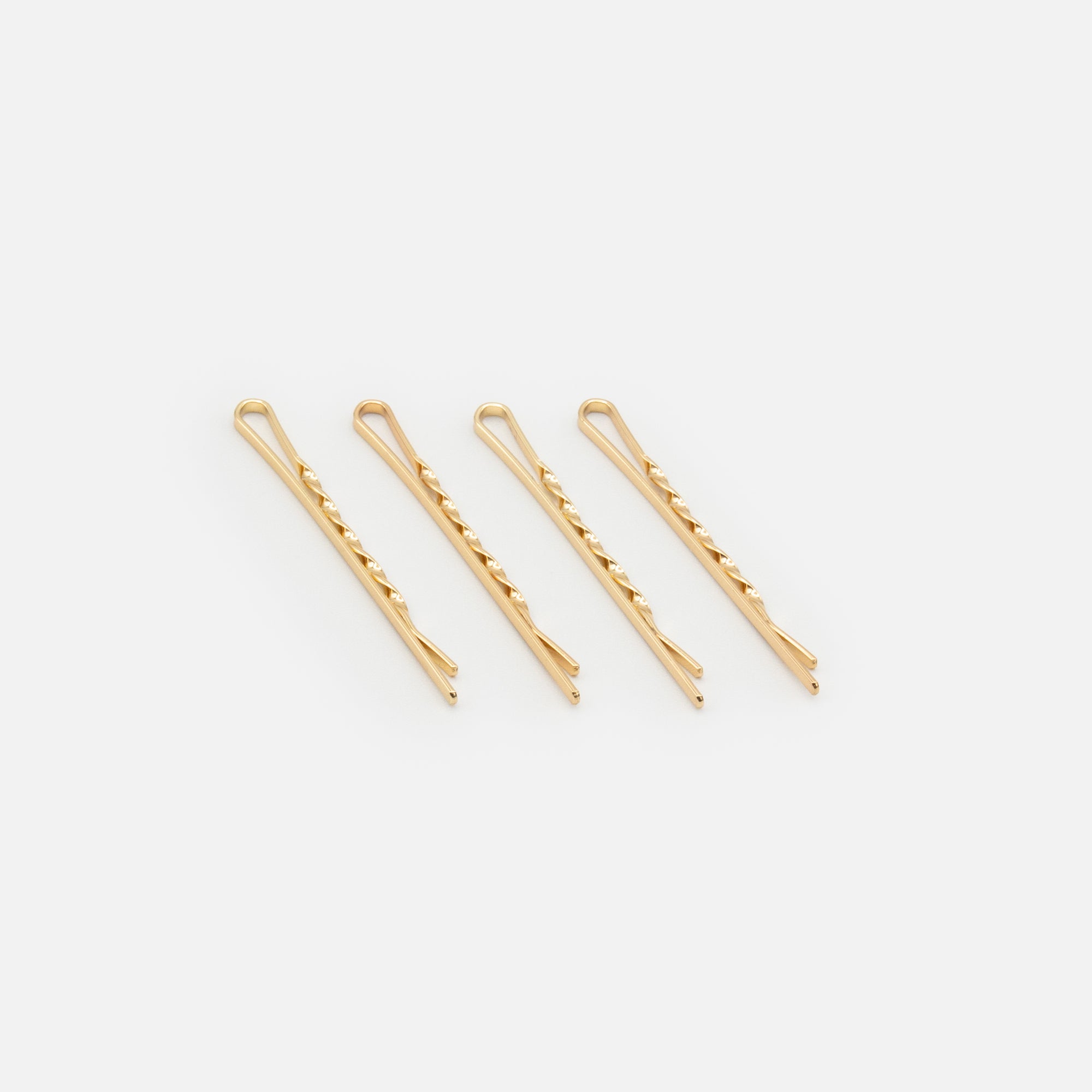 Set of four twisted gold clips