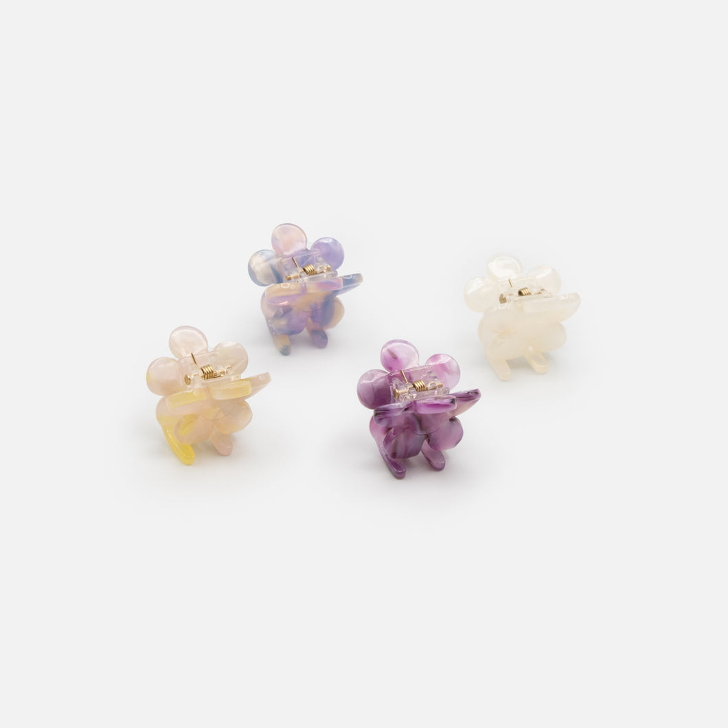 Set of four small white and purple flower clips
