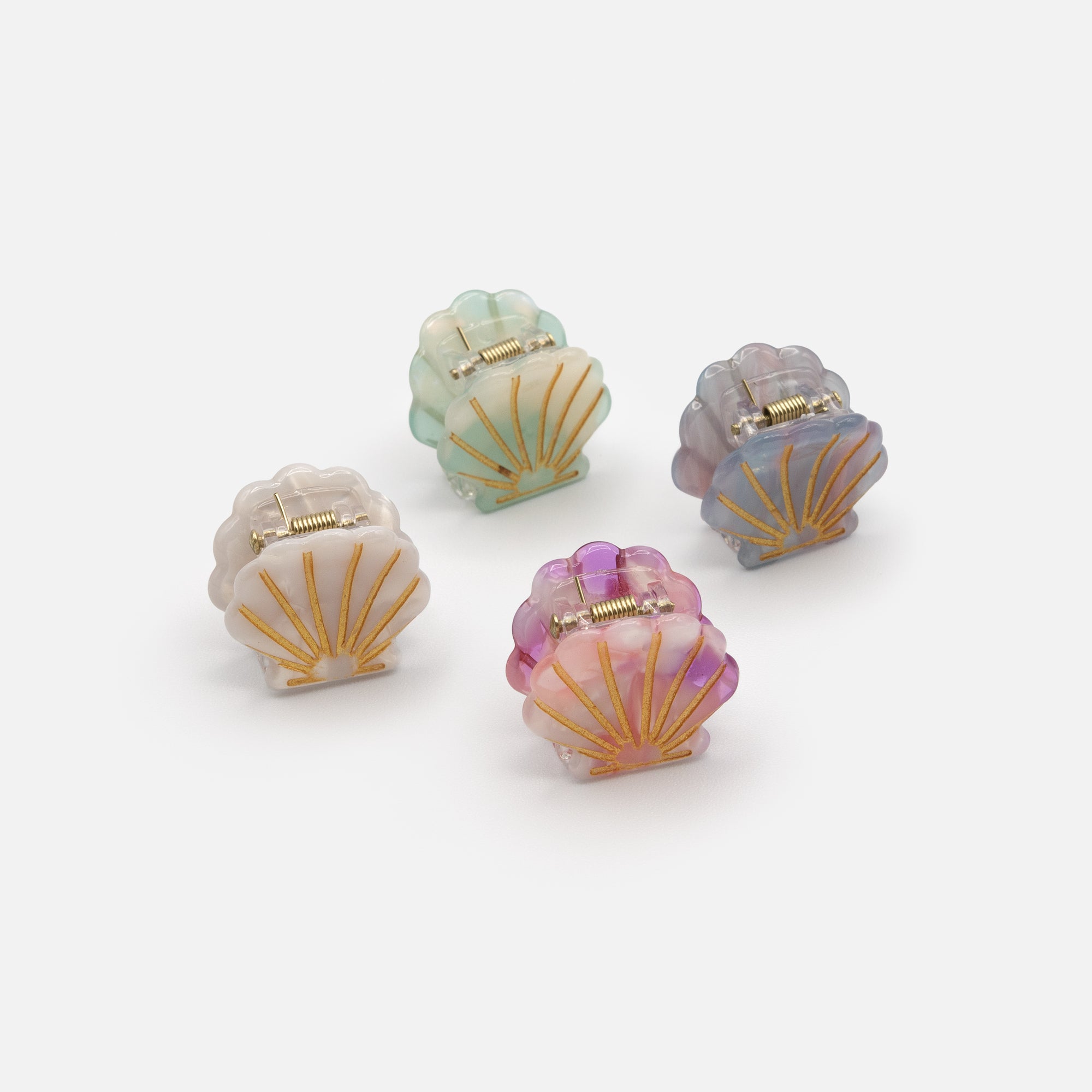 Set of four small multicolored shell clips