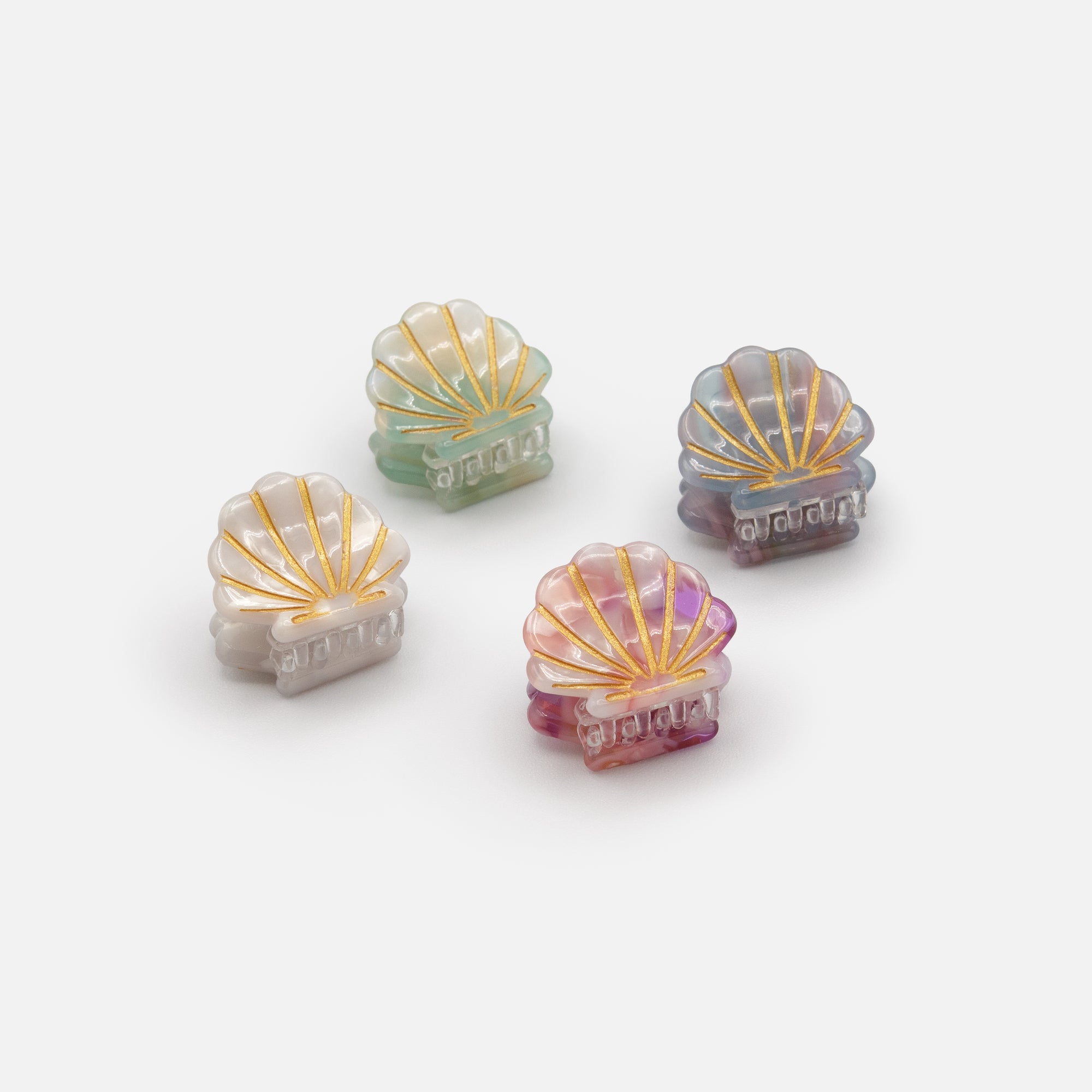 Set of four small multicolored shell clips