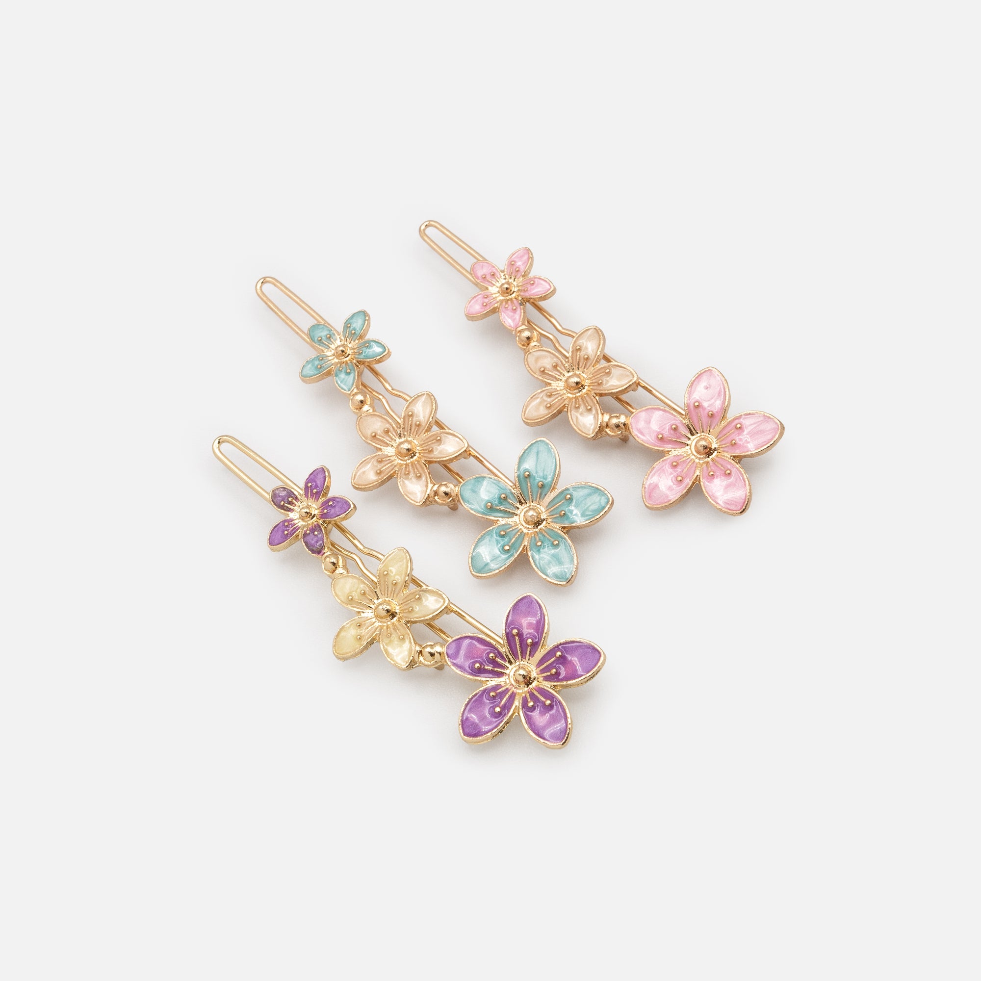 Set of three brightly colored gold floral clips