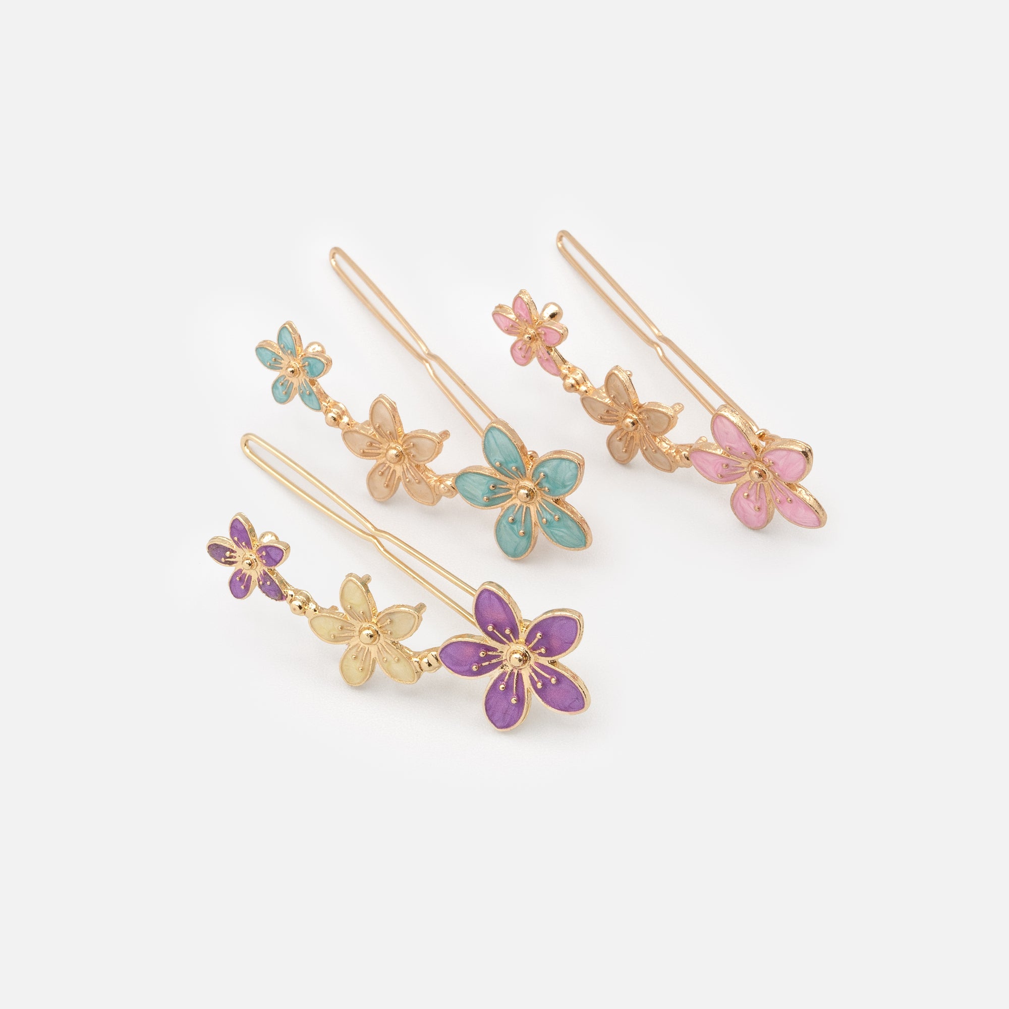 Set of three brightly colored gold floral clips