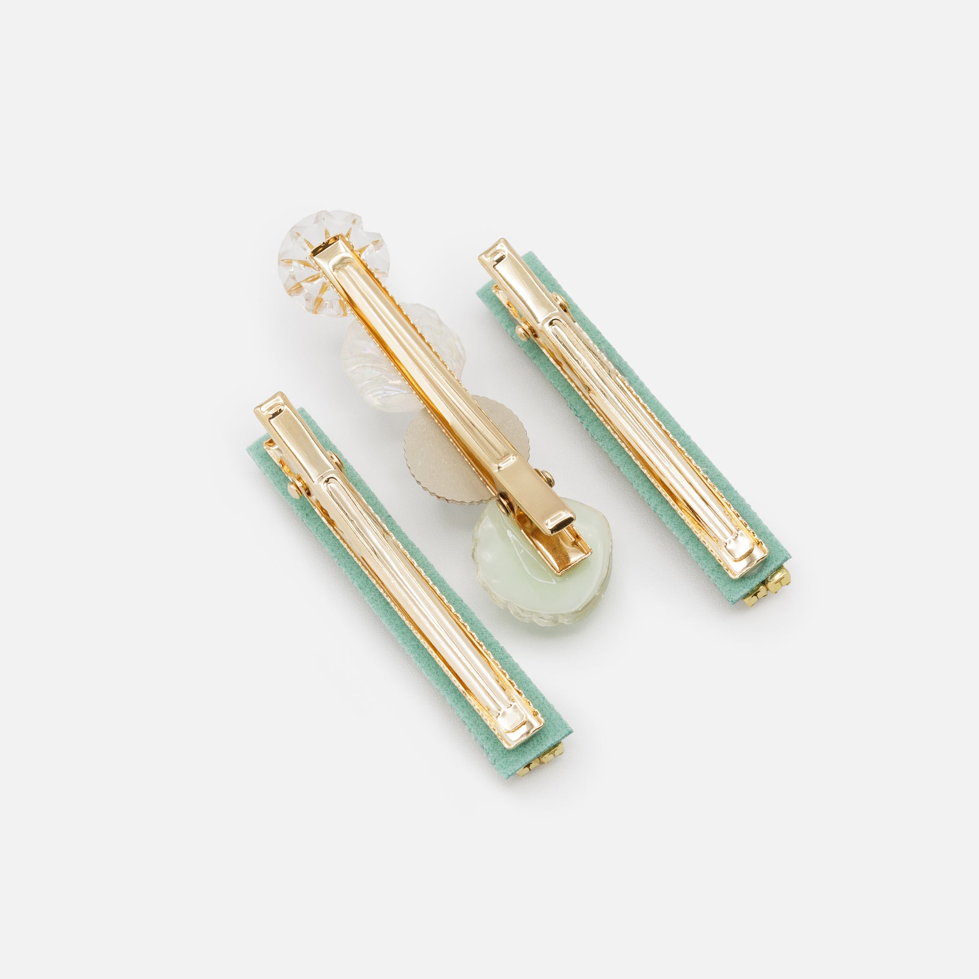 Set of three gold and green shell clips