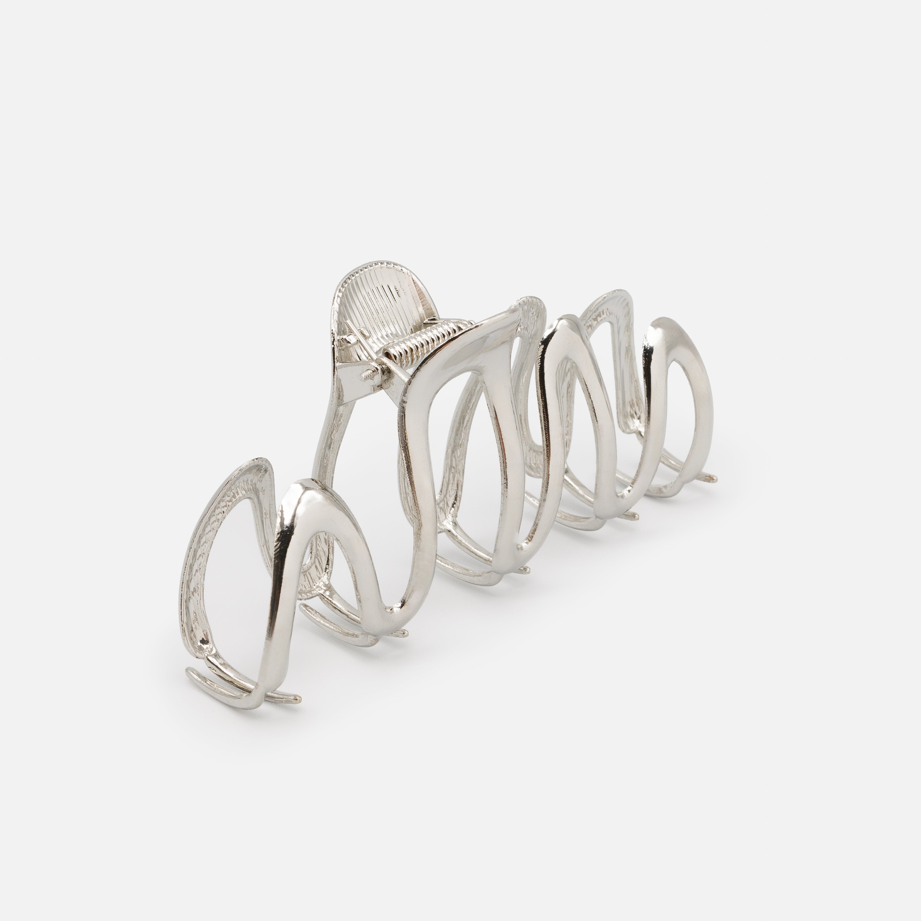 Very large silver clip with sinuous legs