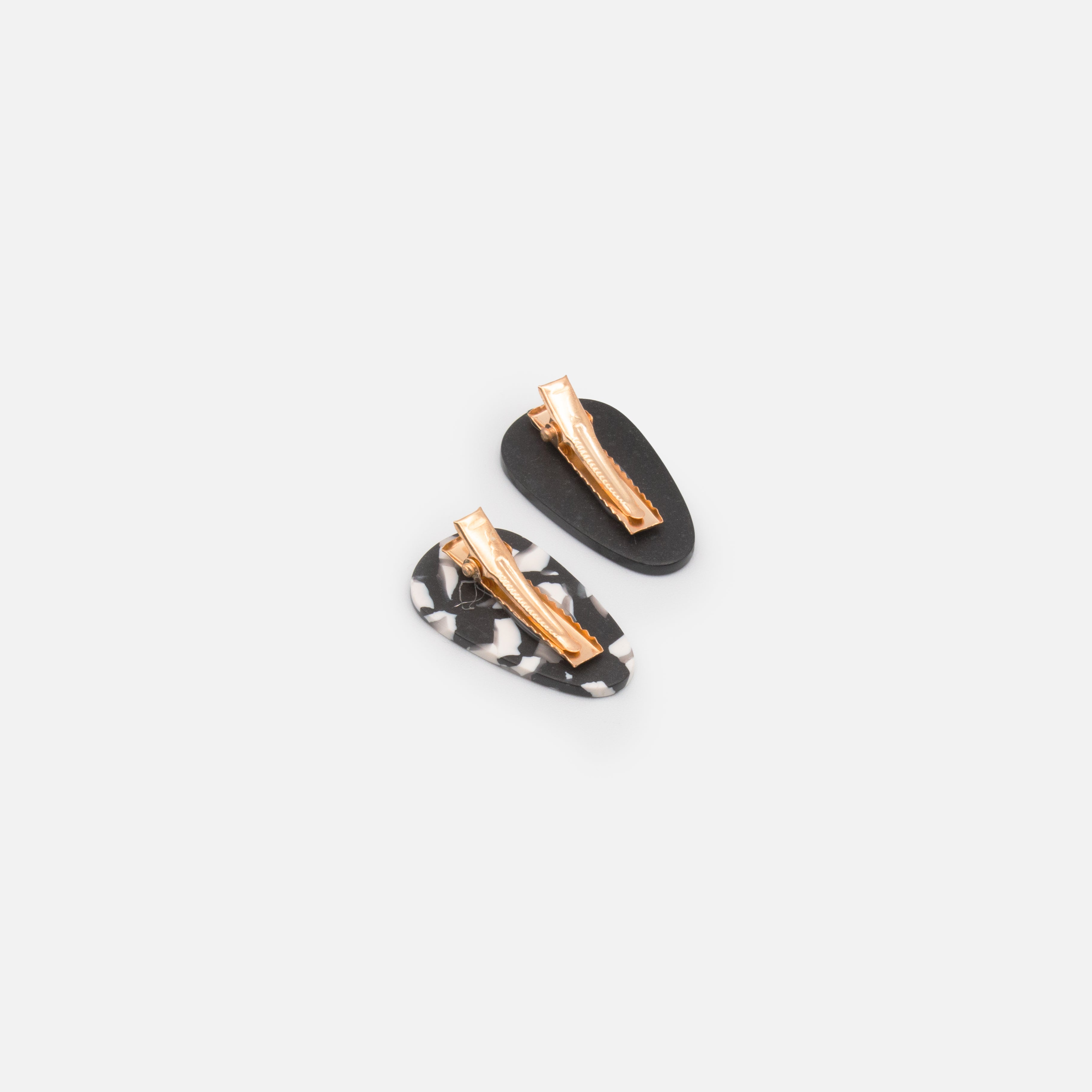Duo of small black and speckled clips