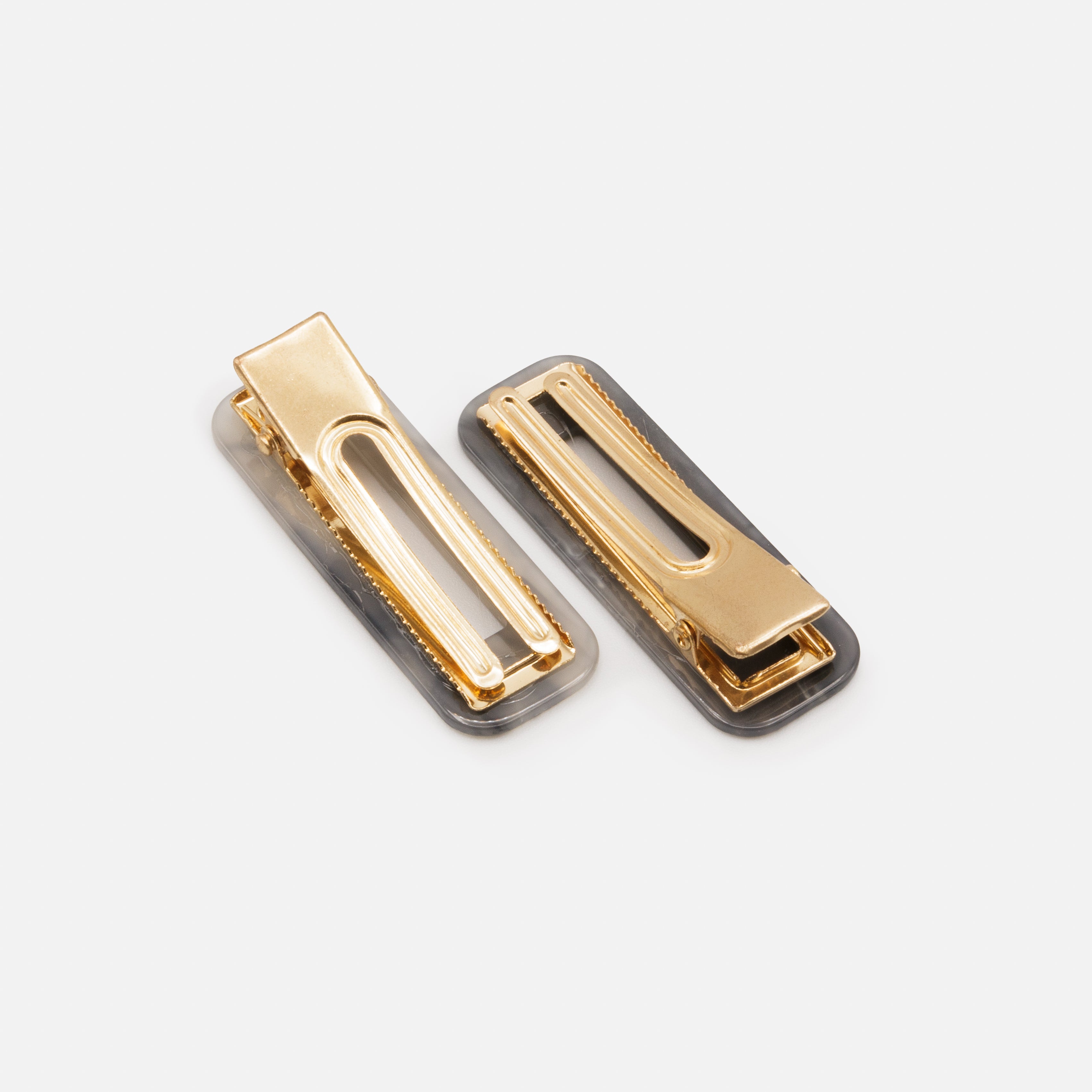 Duo of neutral toned plastic clips