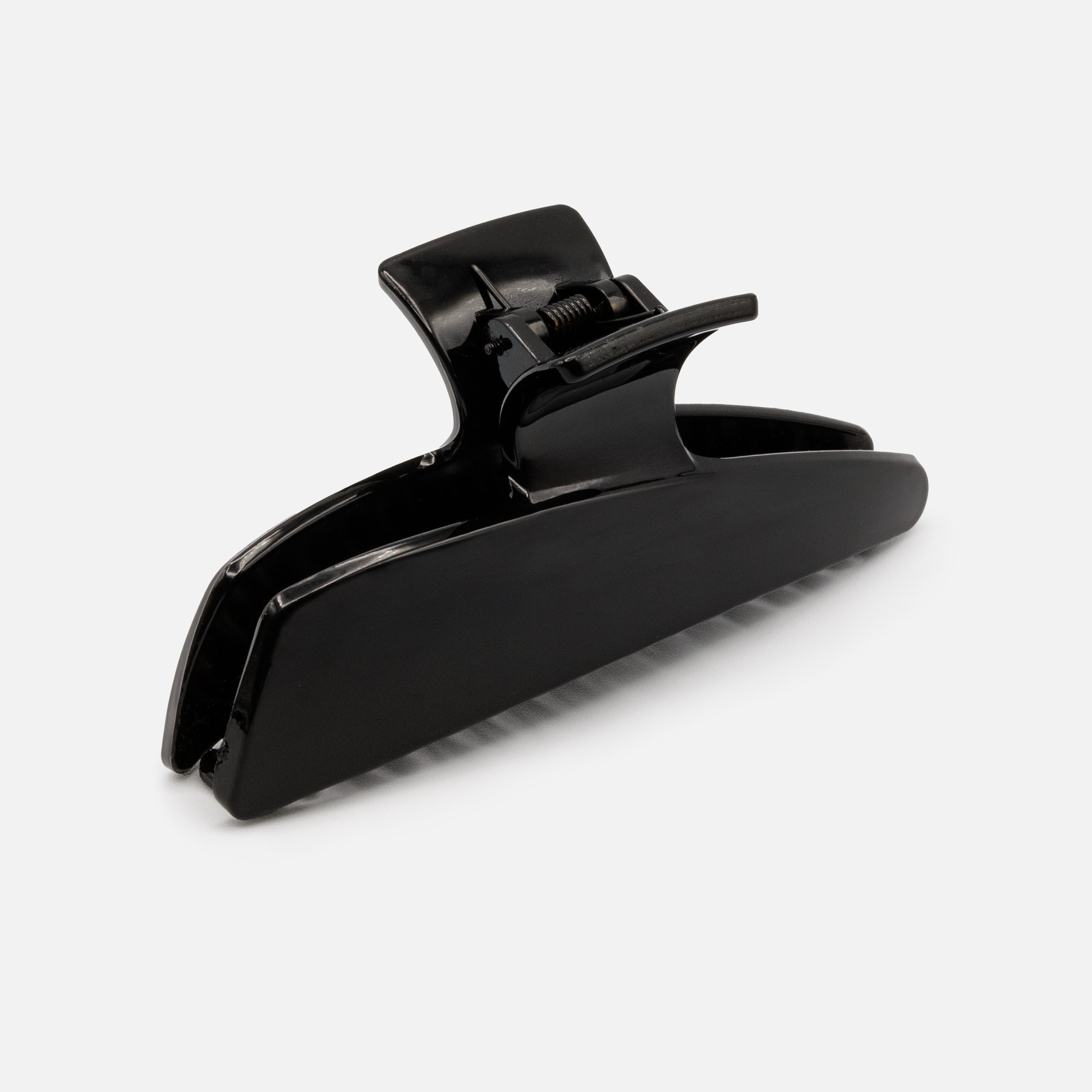 Black geometric plastic clip with a glossy finish