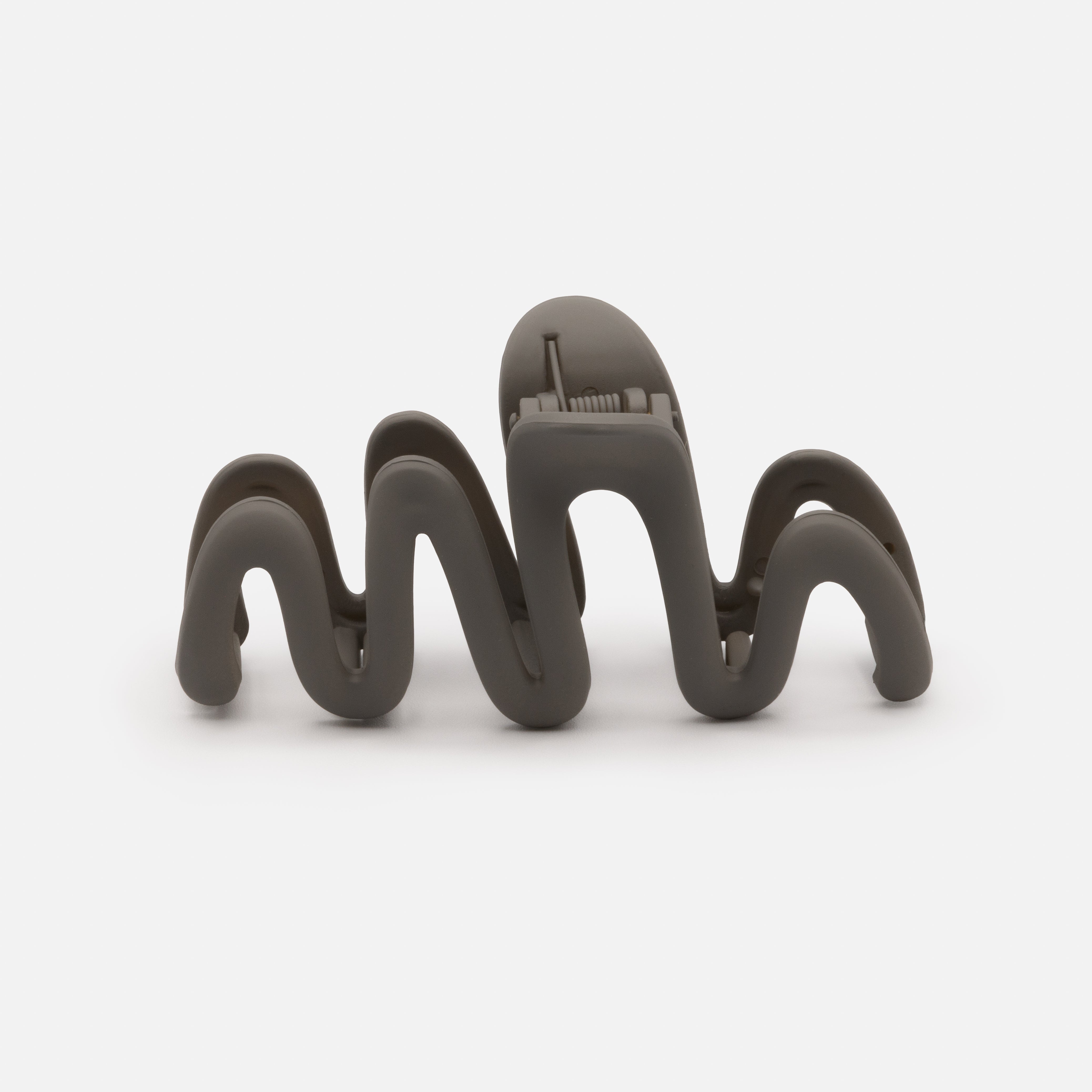 Dark gray wavy plastic clip with matte finish