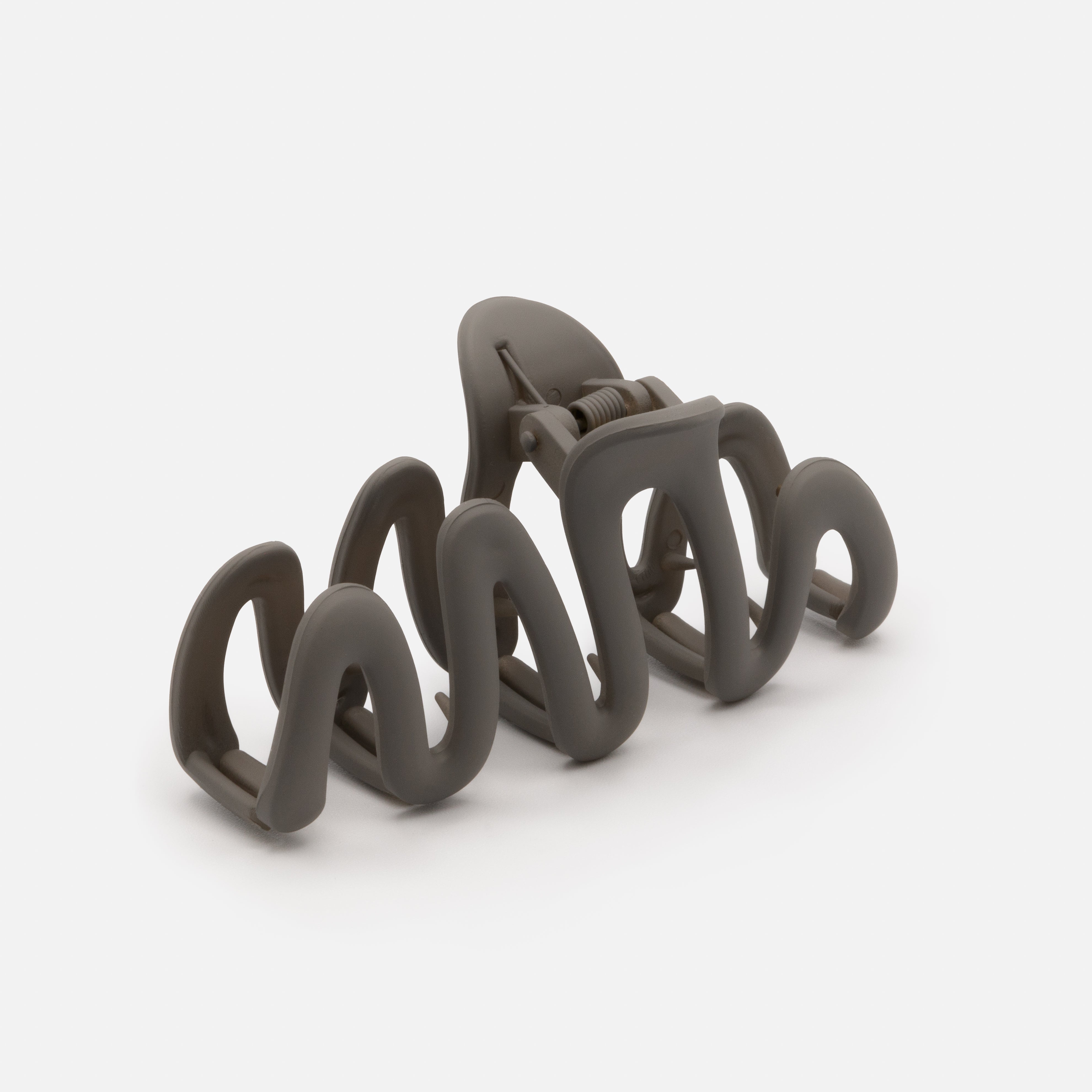 Dark gray wavy plastic clip with matte finish