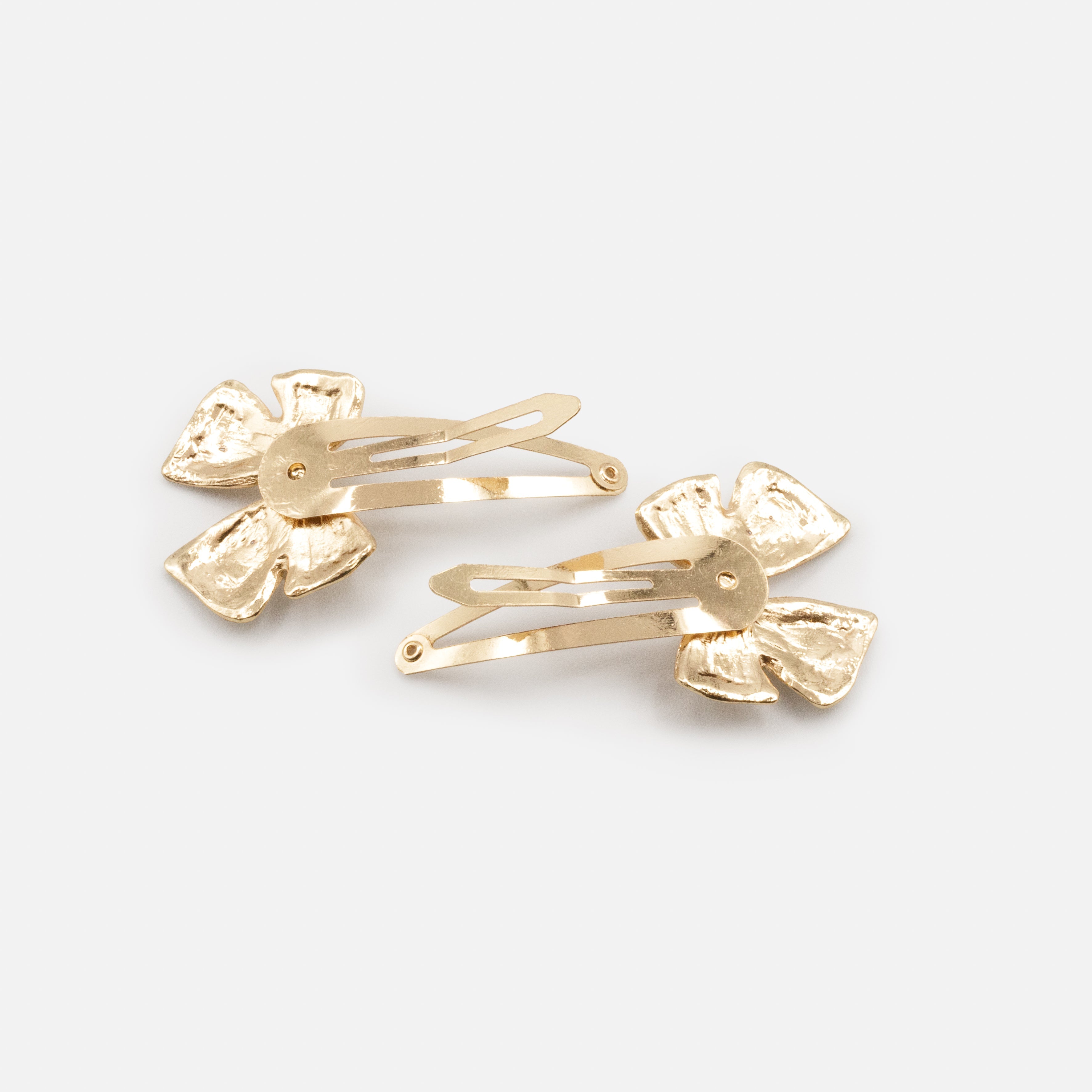 Pair of gold metal clips with buckle