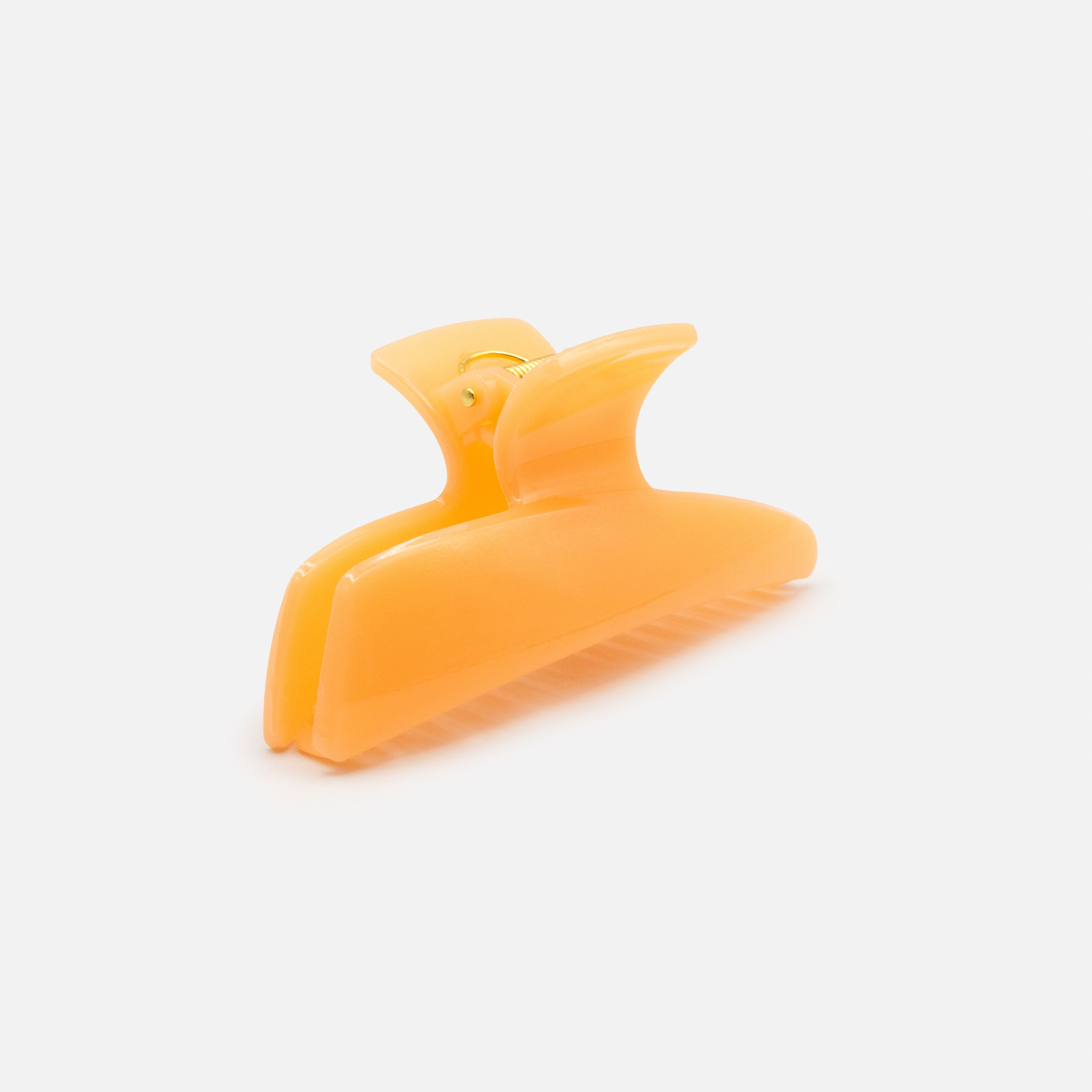 Geometric peach plastic clip with glossy finish