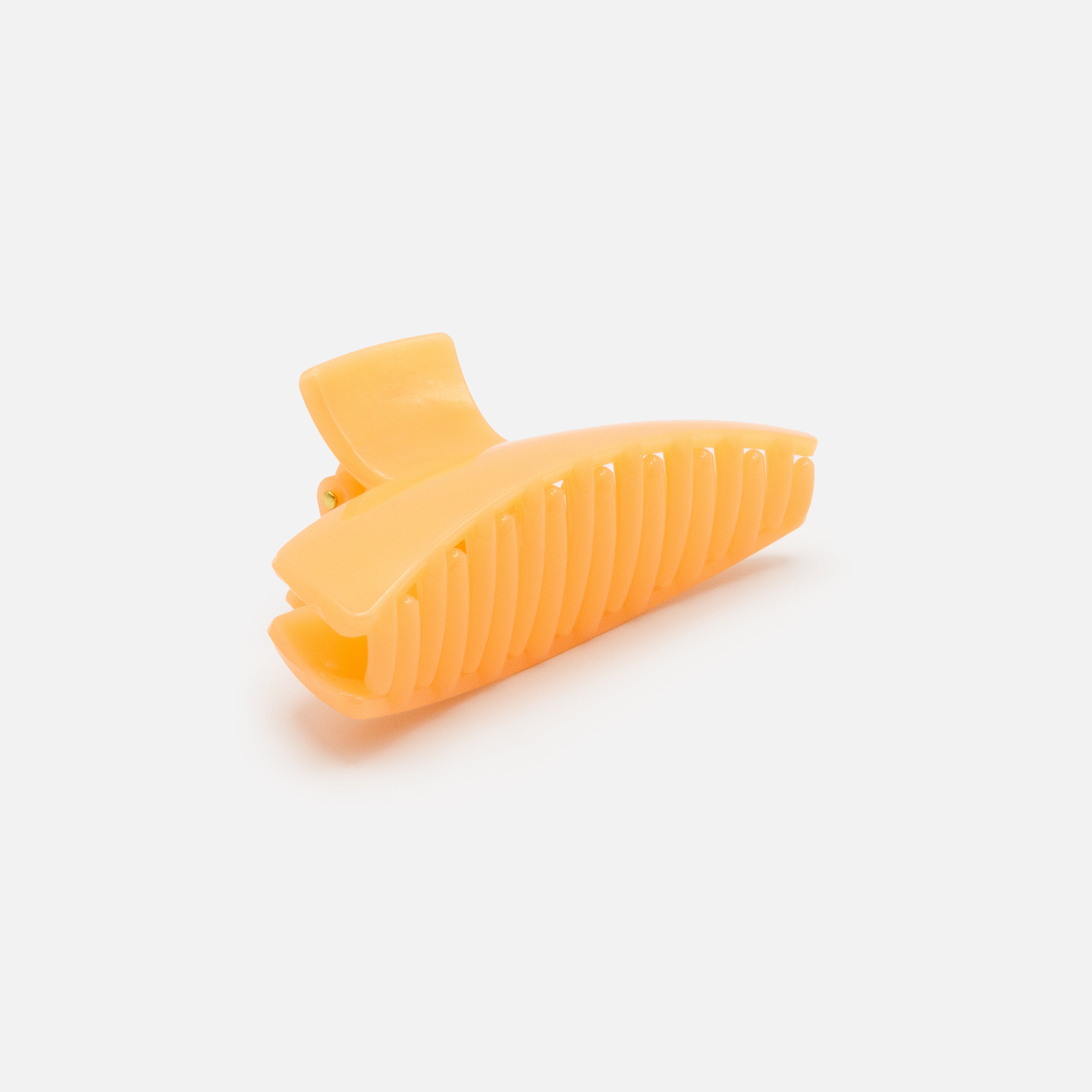 Geometric peach plastic clip with glossy finish