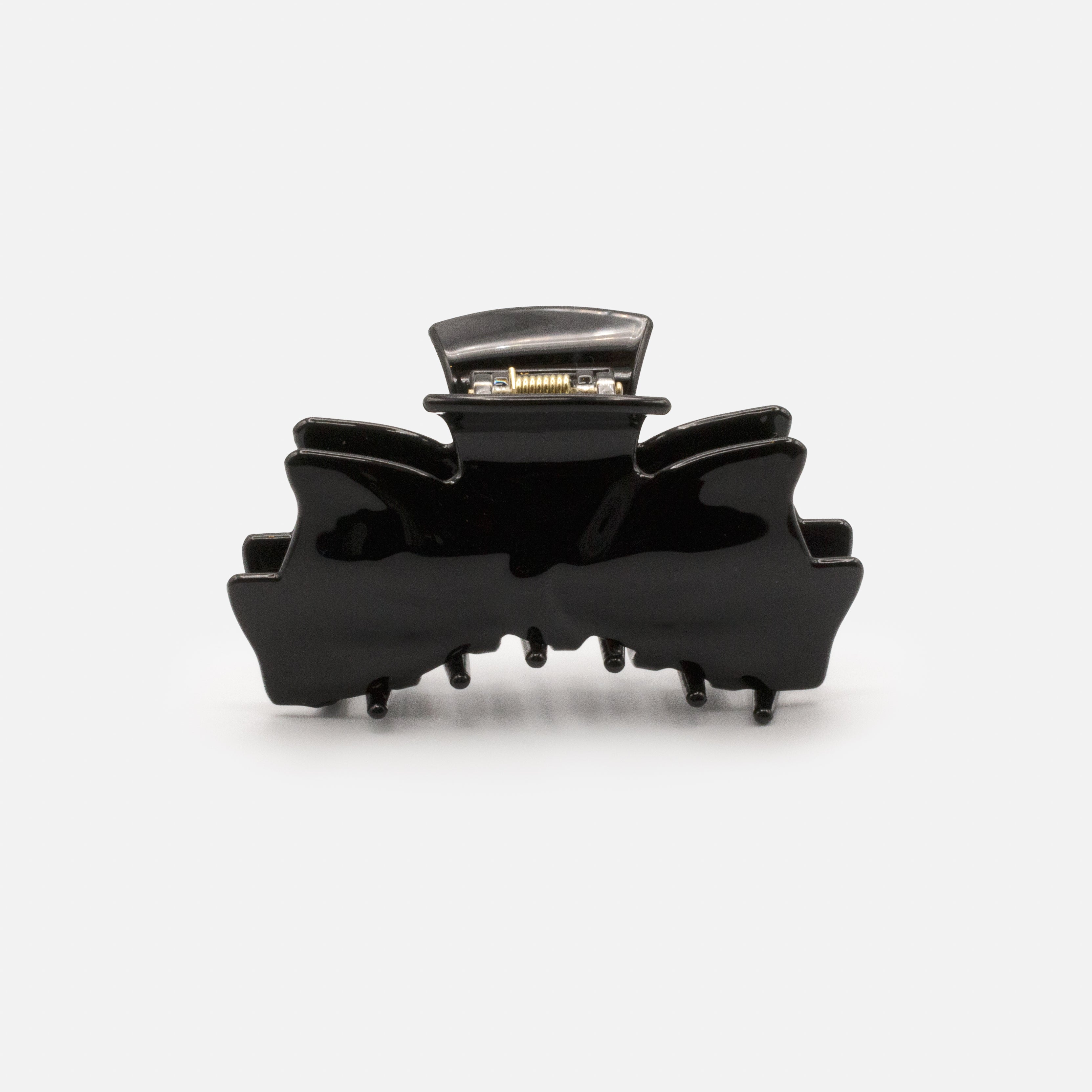 Black plastic loop clip with a glossy finish
