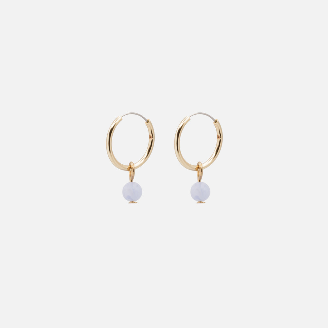 Golden hoop earrings with pale blue round stone charm