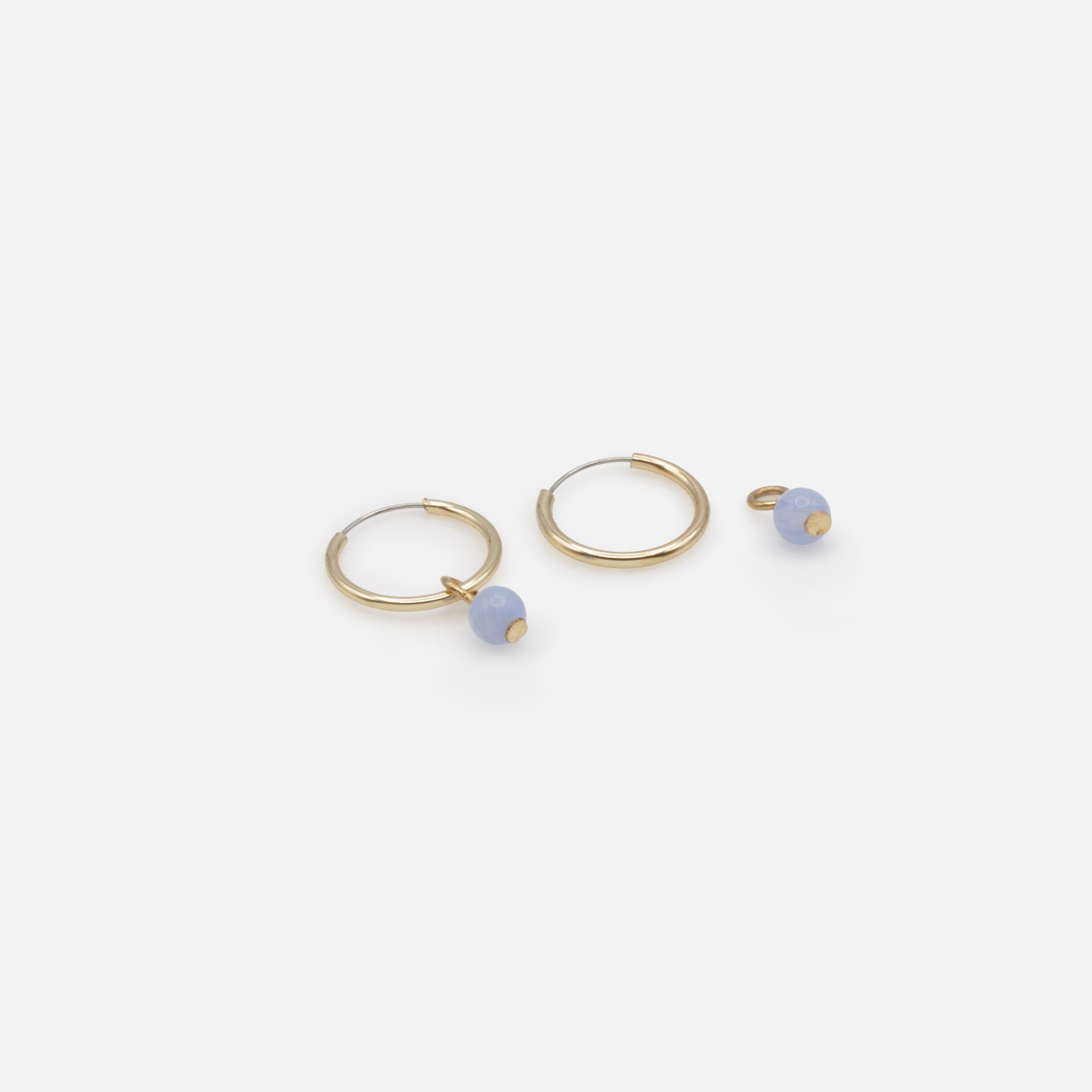 Golden hoop earrings with pale blue round stone charm