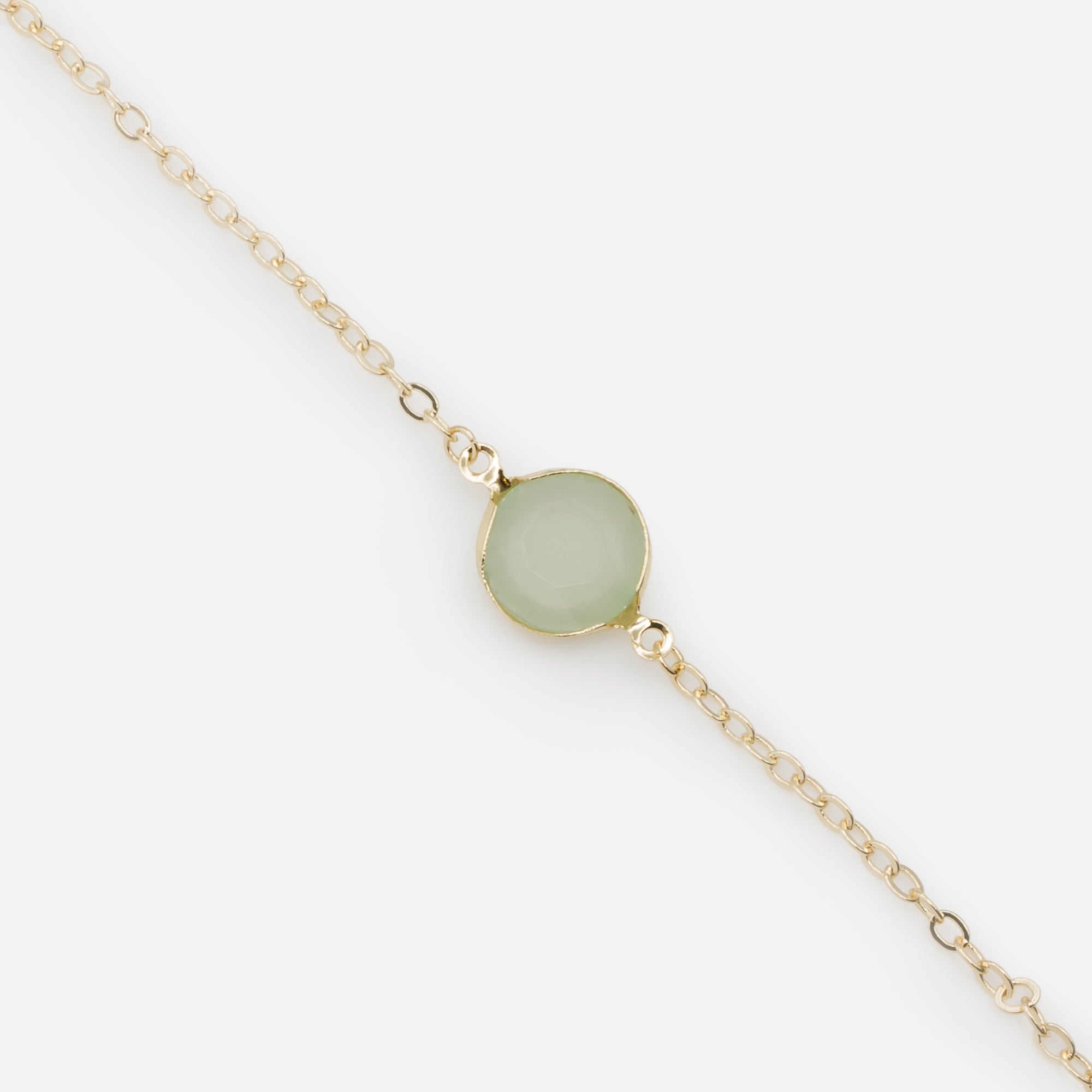 Gold chain link bracelet with pale green circular stone