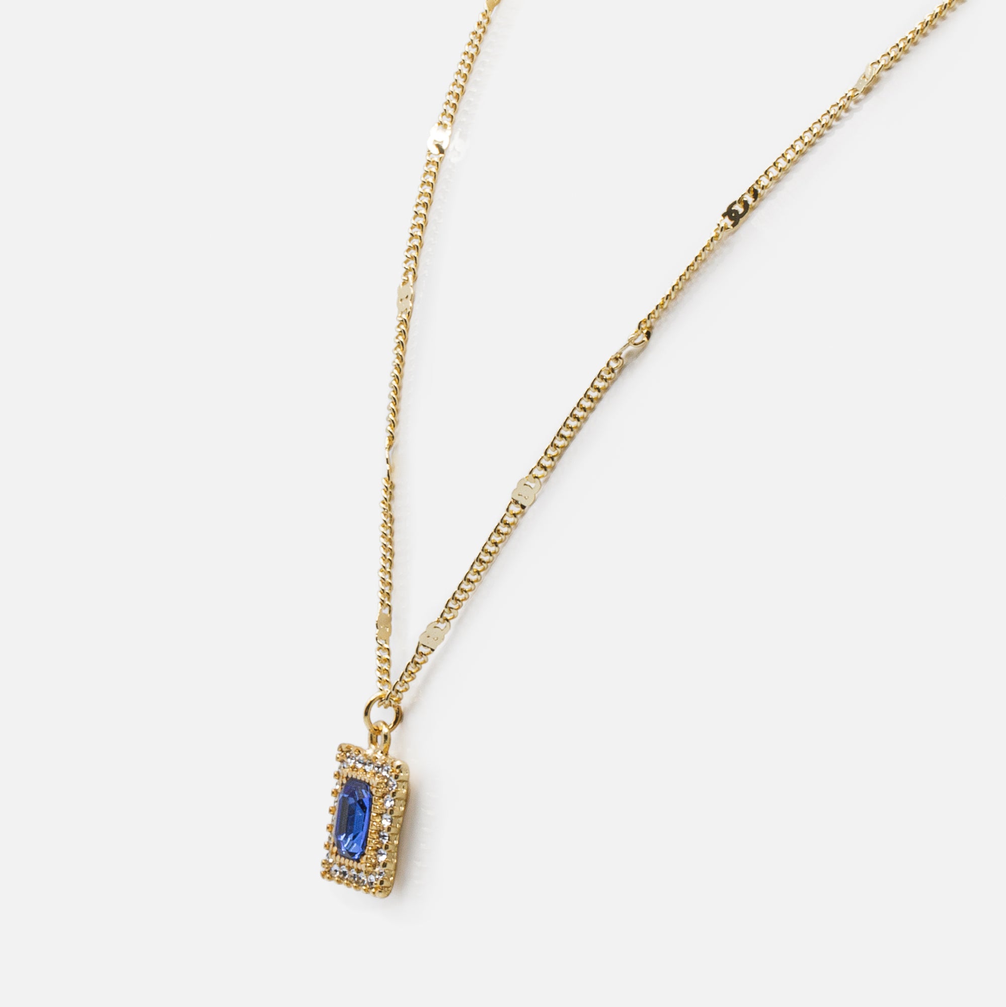 Gold necklace with octagonal sapphire stone pendant framed with cubic zirconia