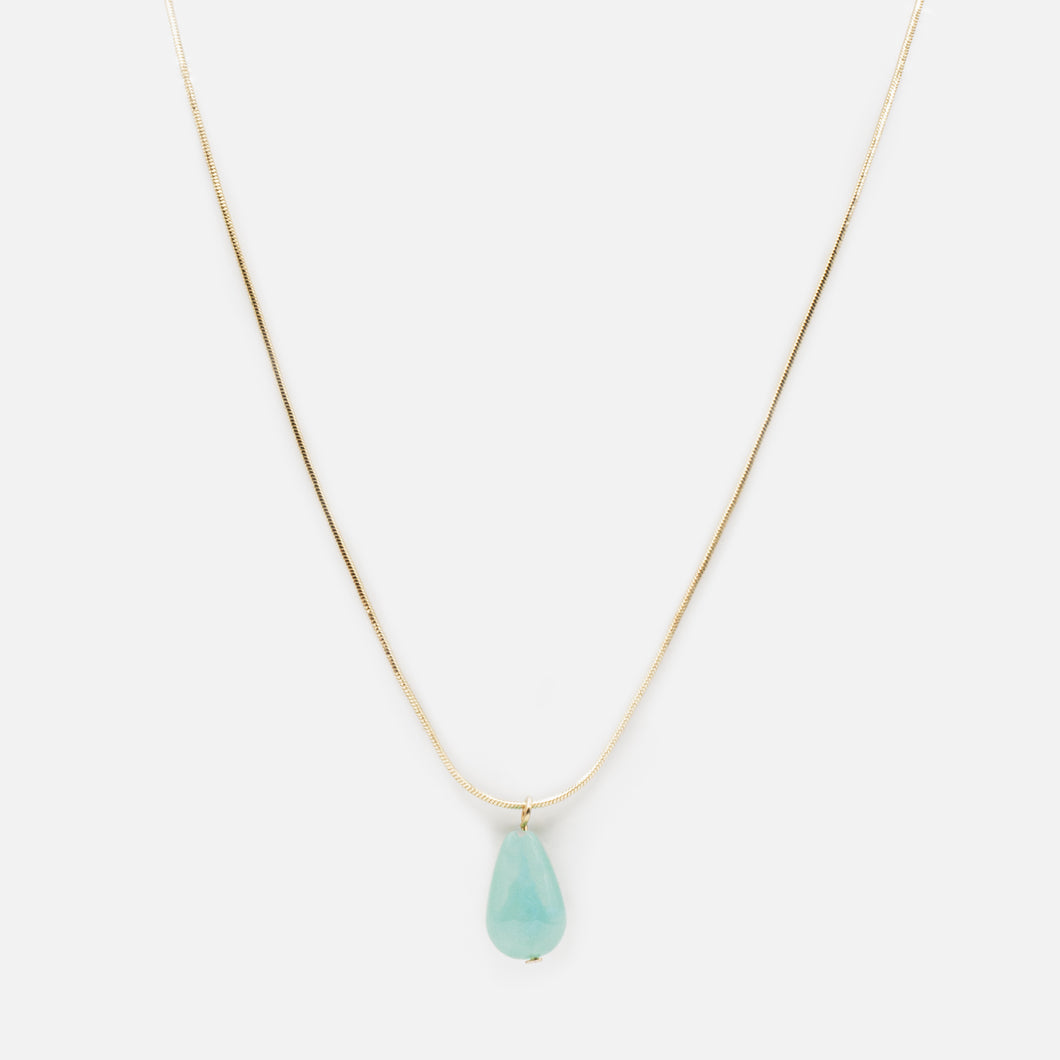 Gold necklace with large turquoise stone pendant