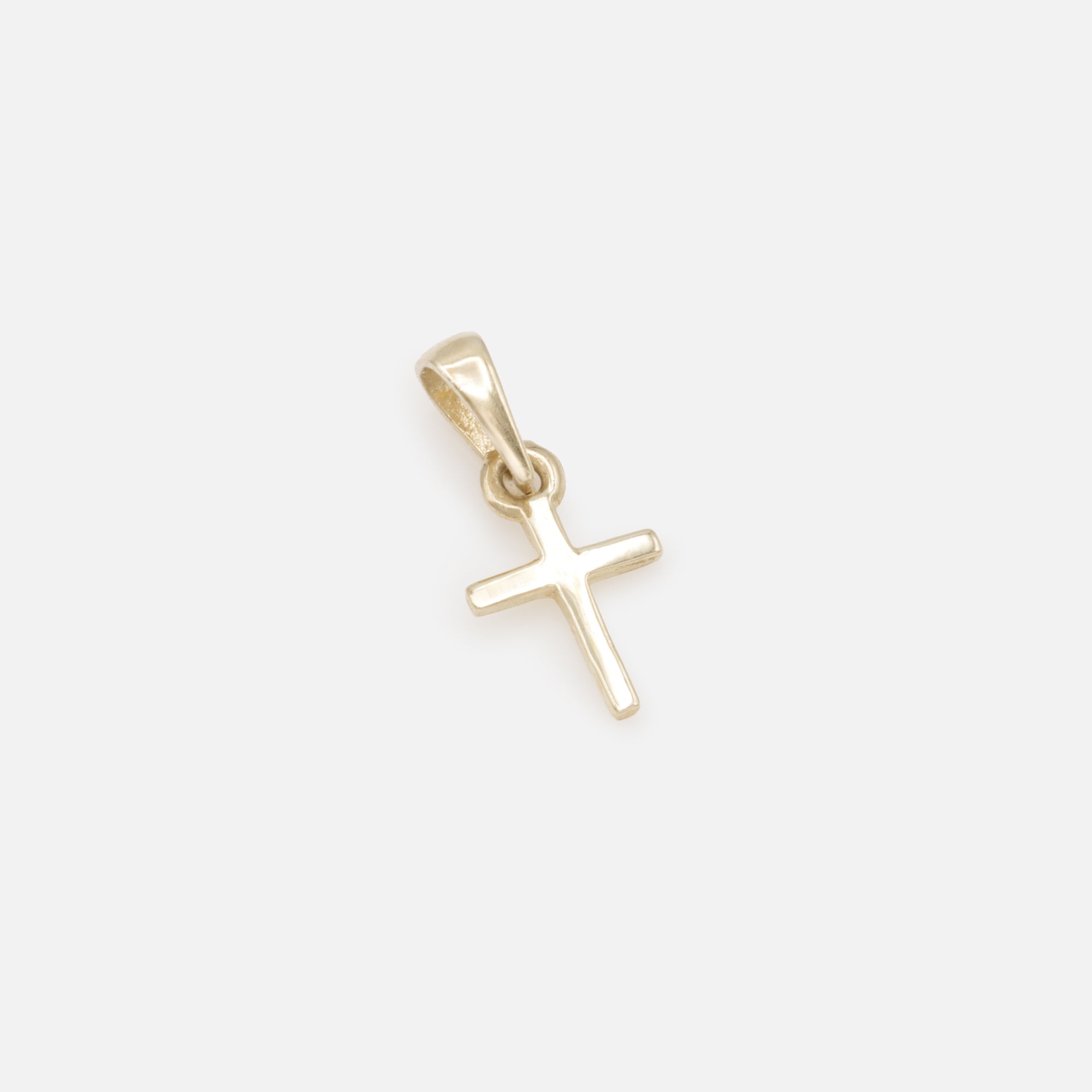 Very small cross charm in 10k gold