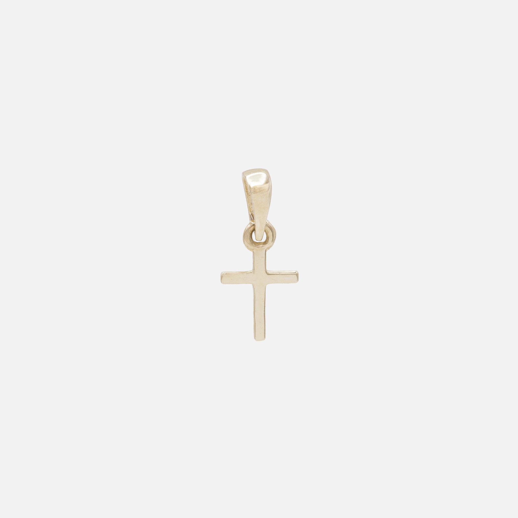 Very small cross charm in 10k gold