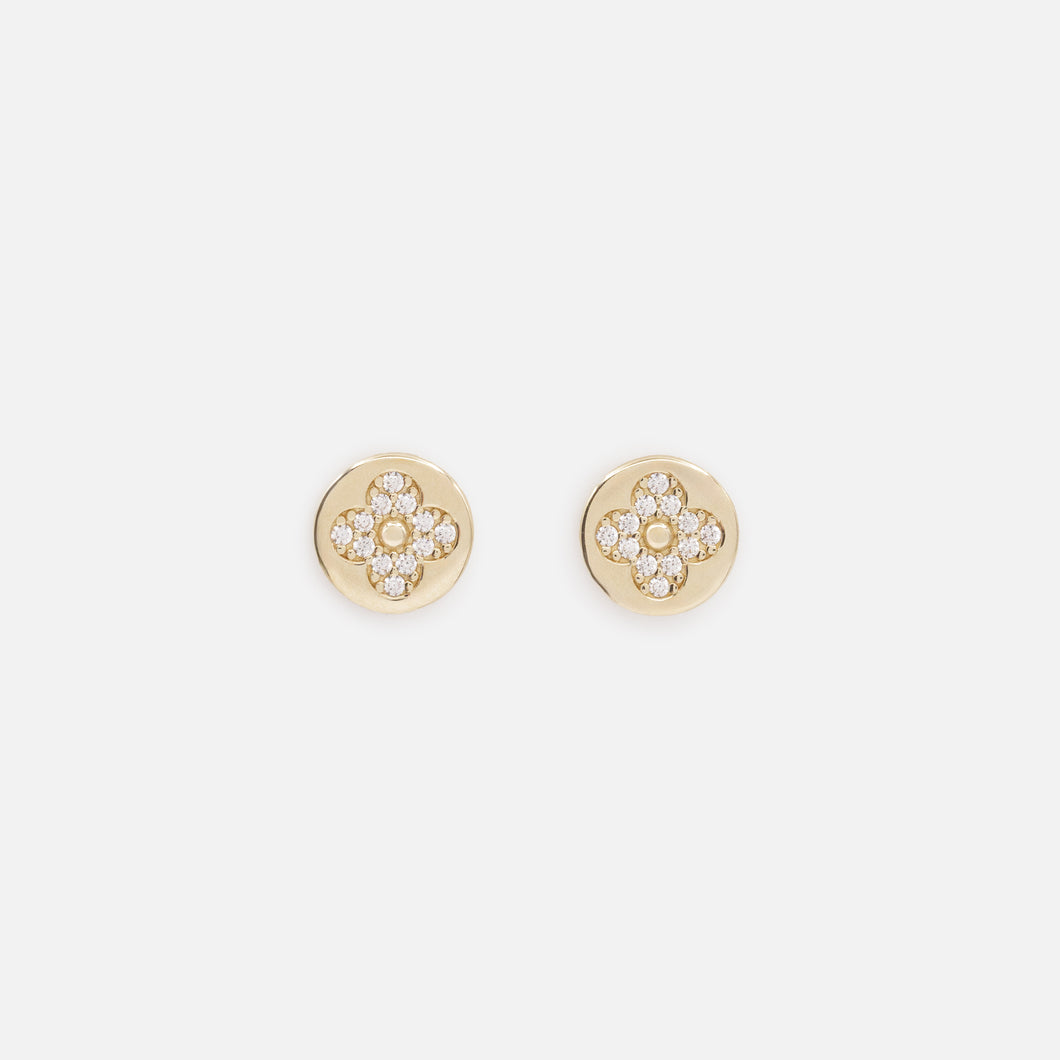 Small cubic zirconia flower earrings on a gold background in 10 carat gold