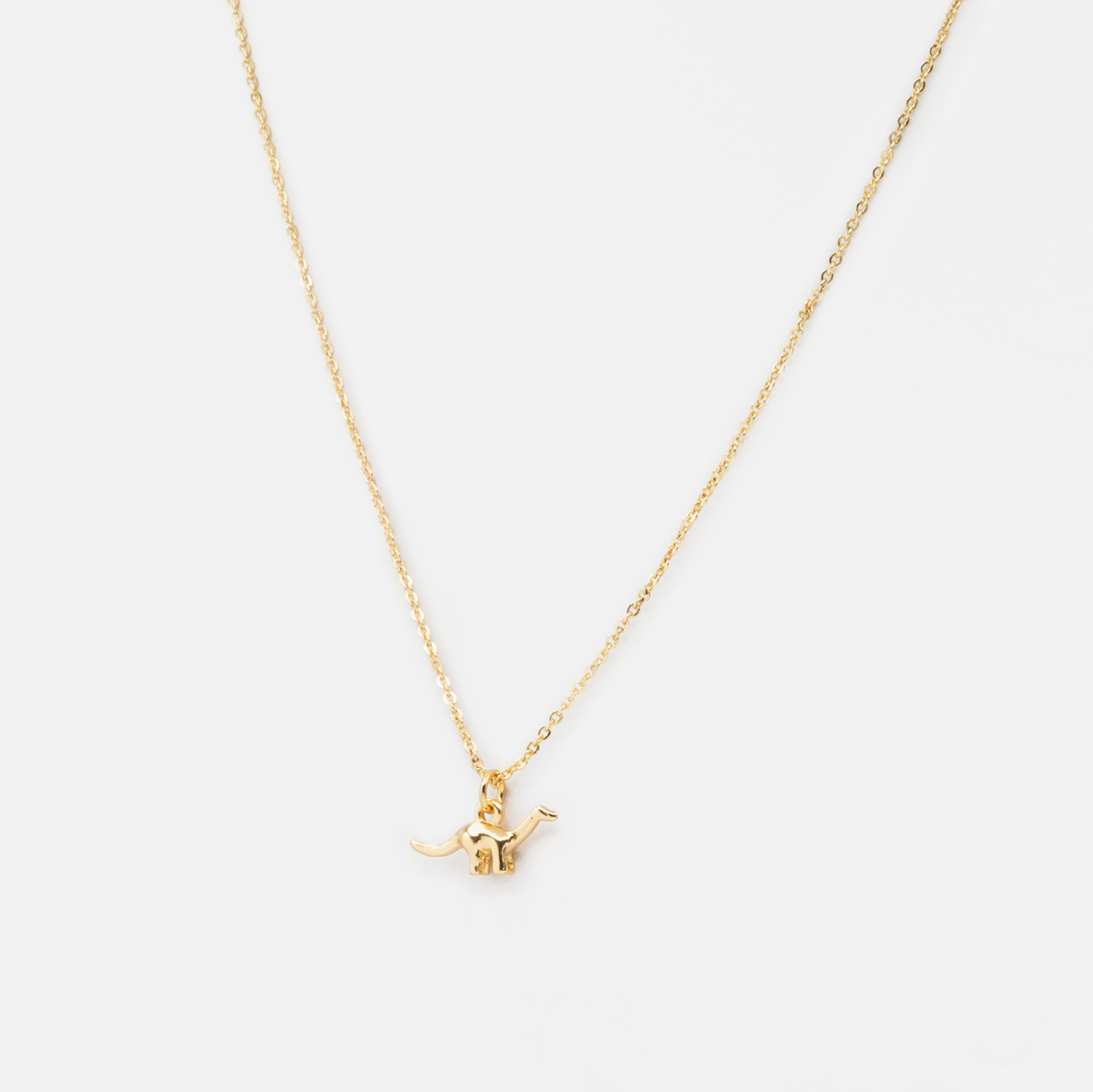 Golden chain with dinosaur charm