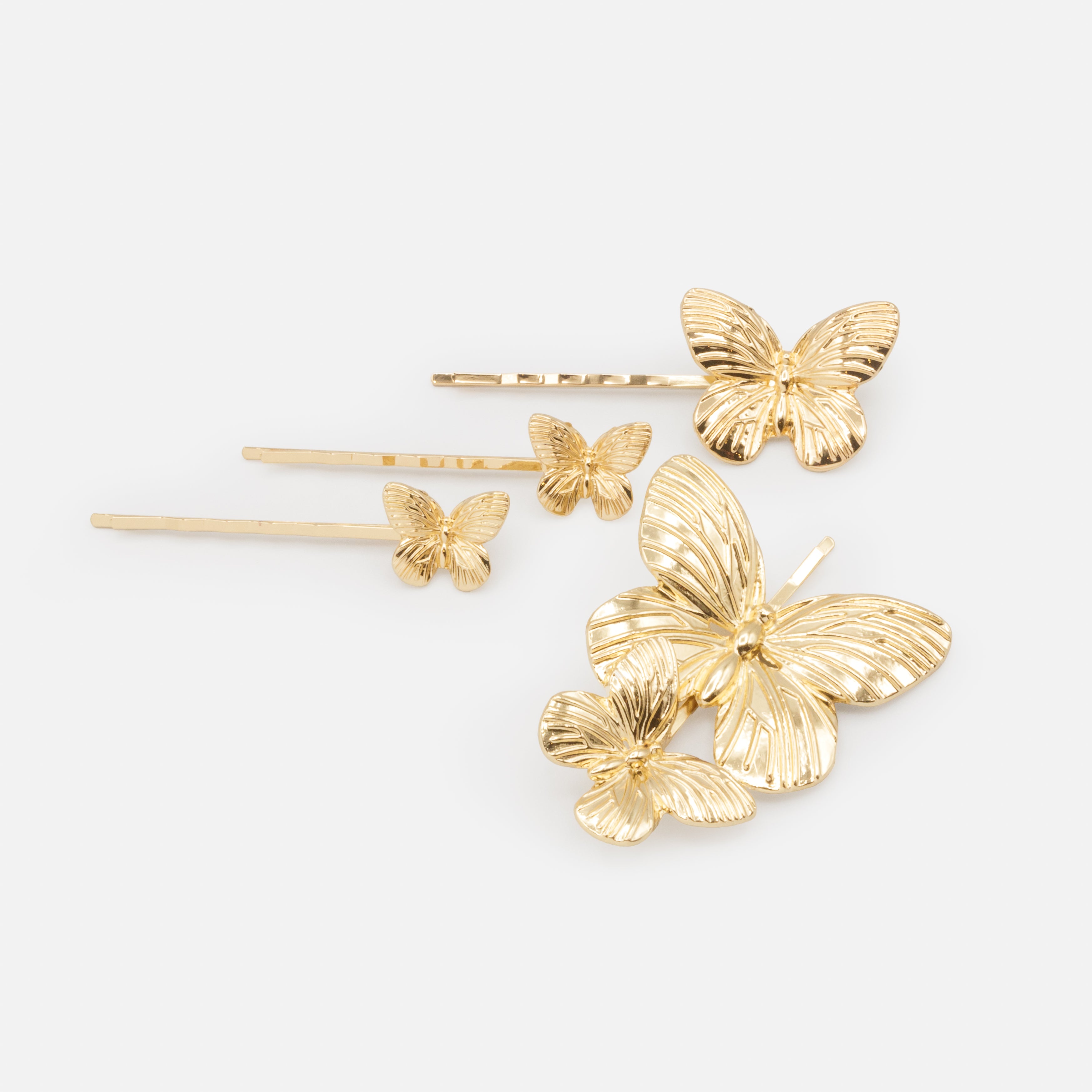 Ensemble de quatre pinces dorées papillons