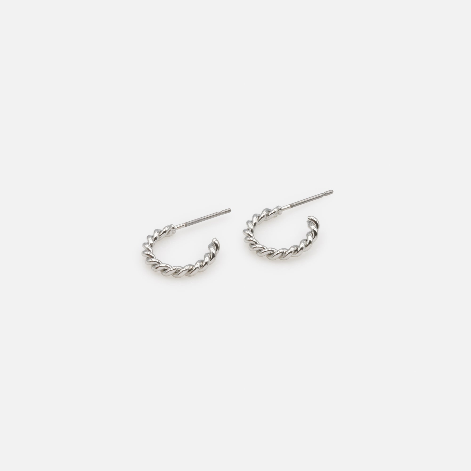 Trio of simple and twisted silver hoop earrings