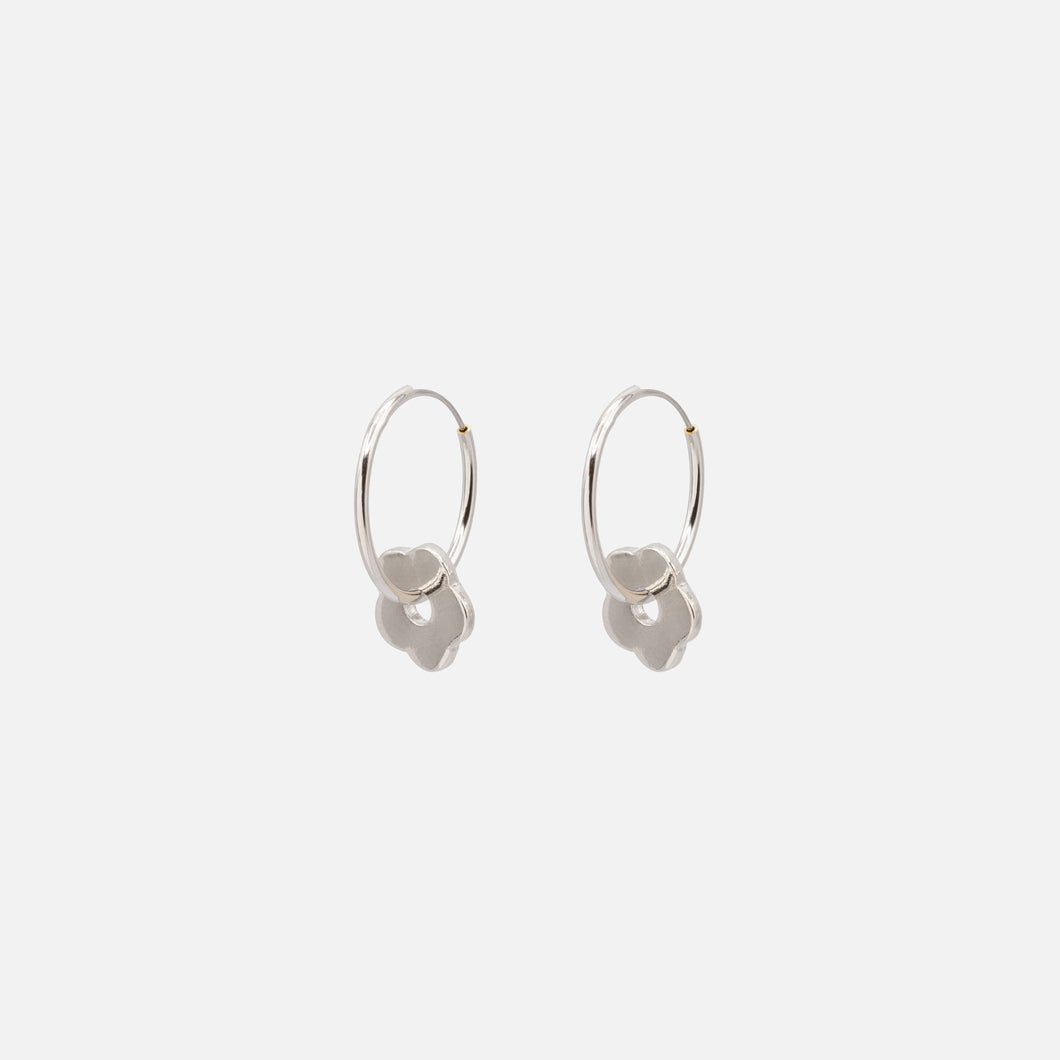 Silver hoop earrings with textured flower charm