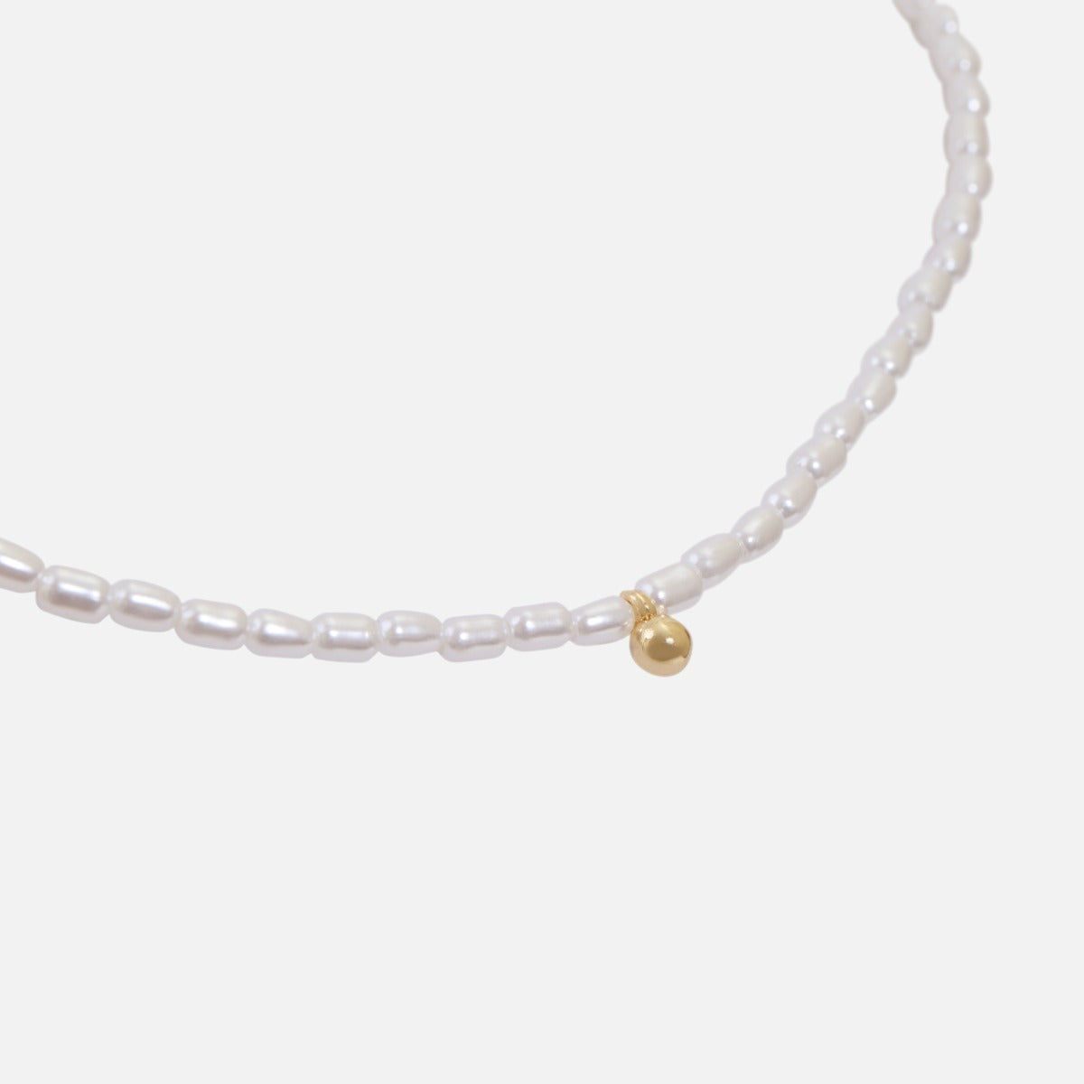 Synthetic pearl necklace and golden ball charm