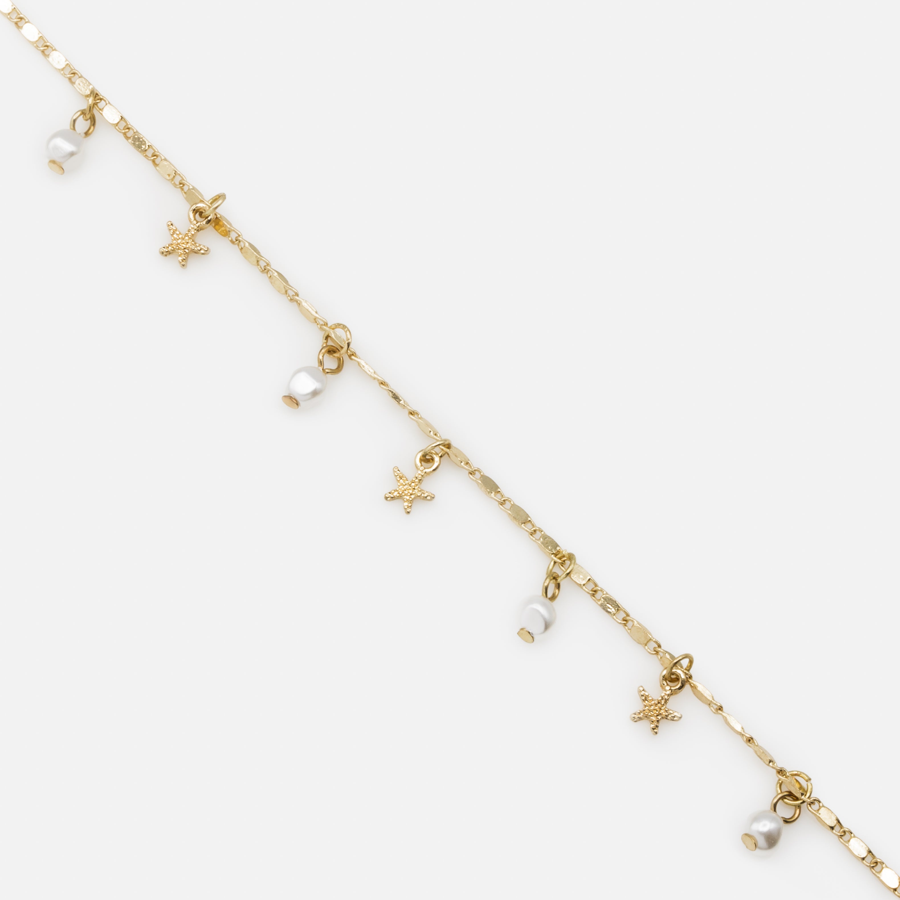 Chaîne de cheville dorée avec perles et étoiles de mer