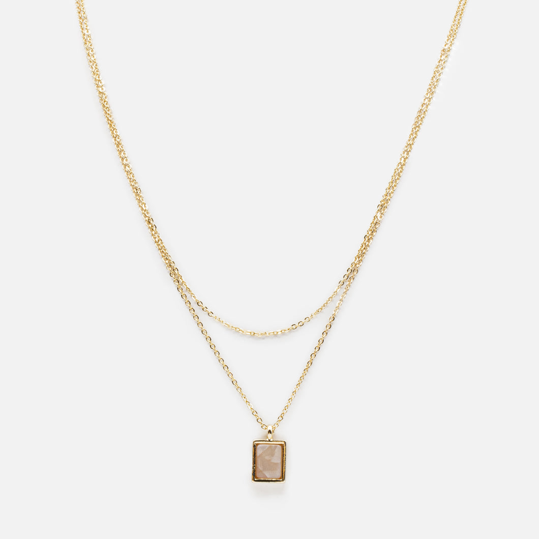 Double golden chain necklace with rectangular pendant and pale pink stone