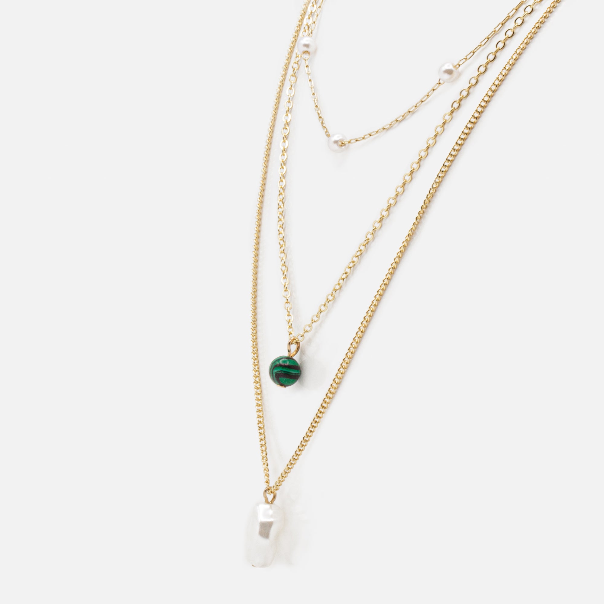 Gold triple chain necklace with flat pearl and zebra green bead pendants