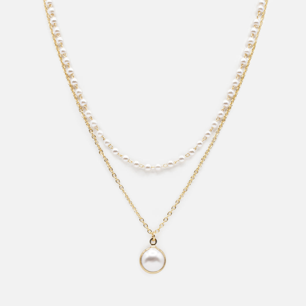 Collier double chaîne pendentif perle dans son anneau doré