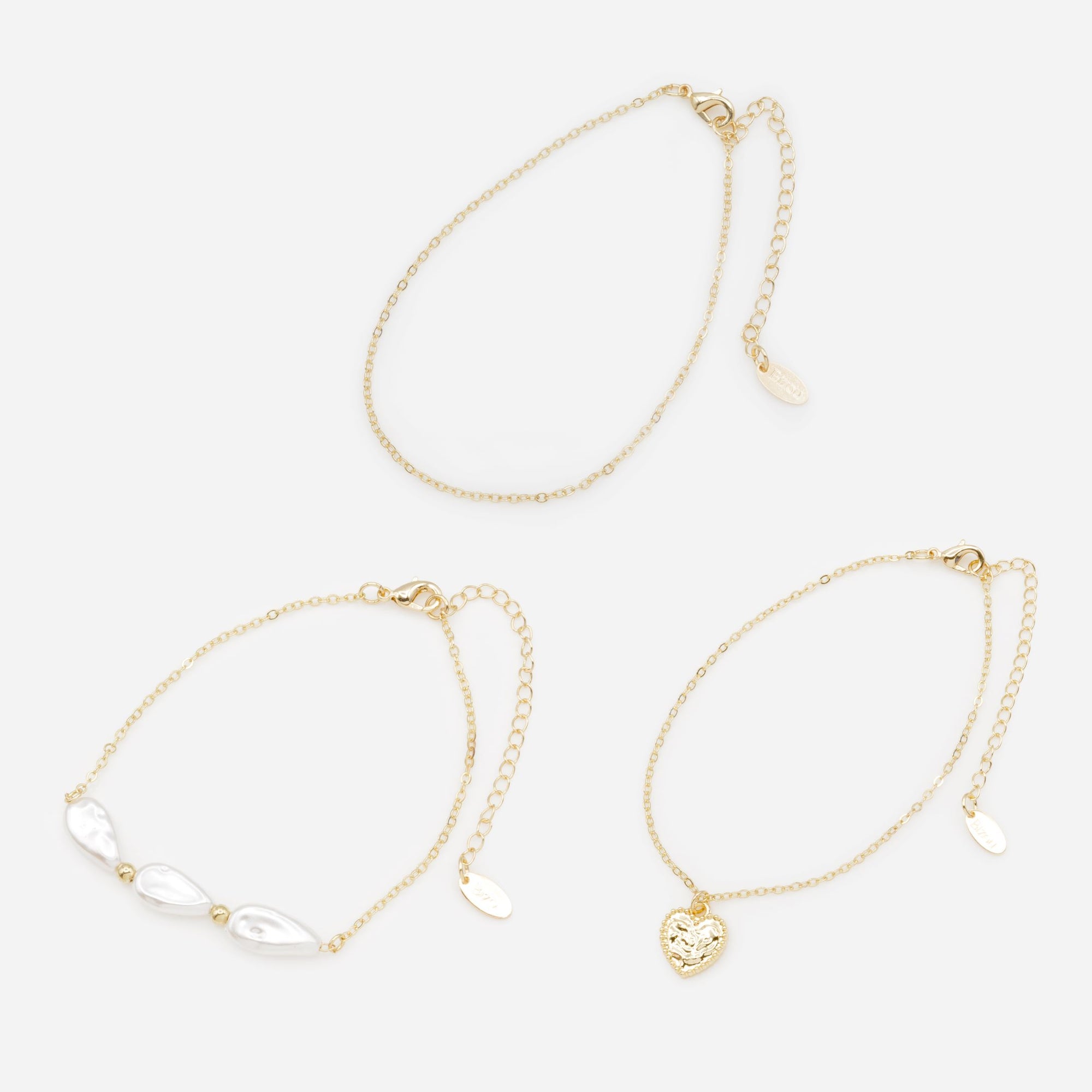 Trio de chaînes de cheville dorées avec perles plates et coeur texturé