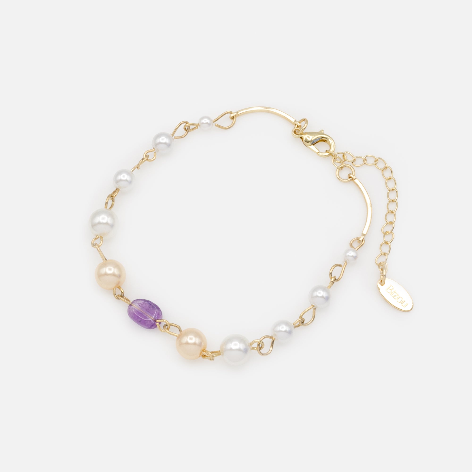 Gold bracelet with two-tone beads and purple stone