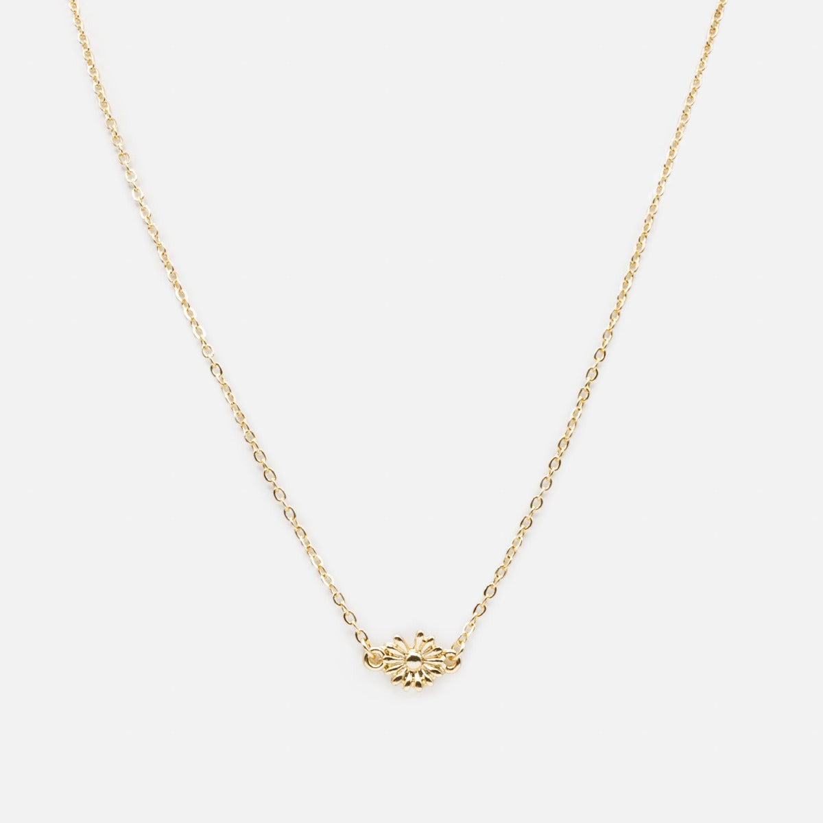 Golden necklace with small flower pendant