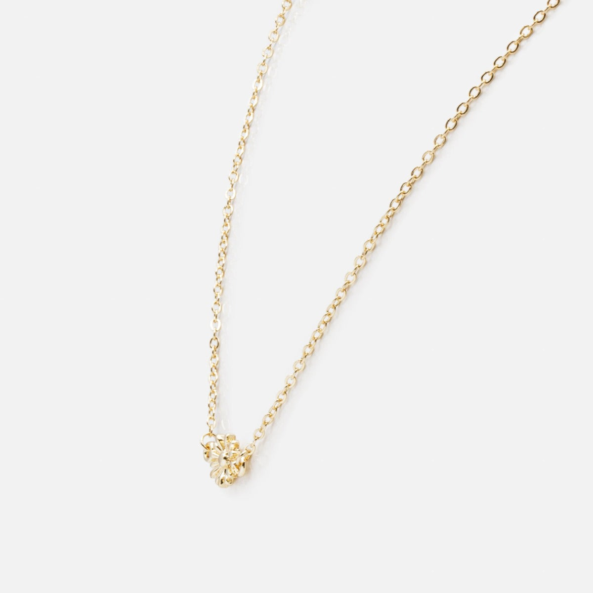 Golden necklace with small flower pendant