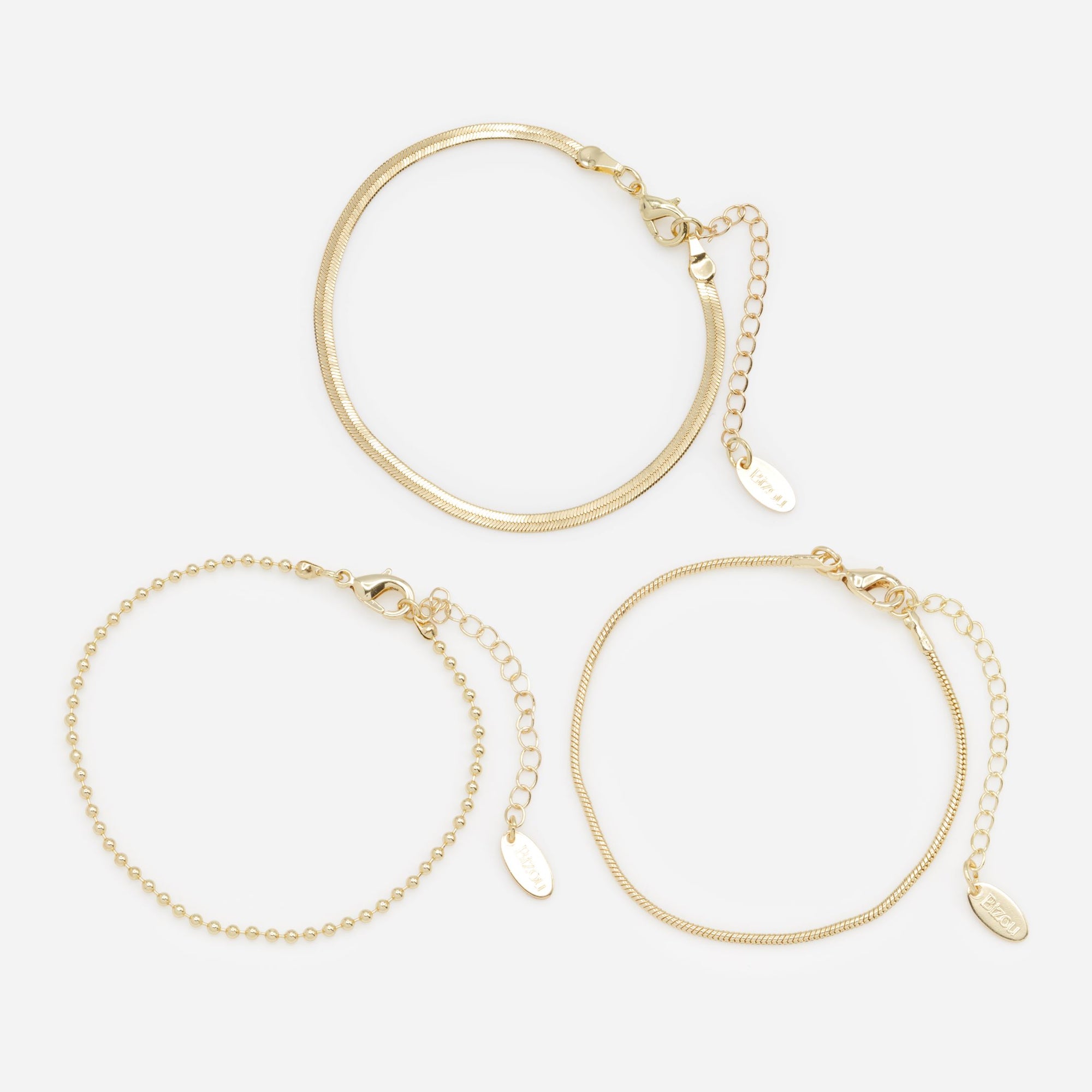 Trio of golden bracelets with varied links