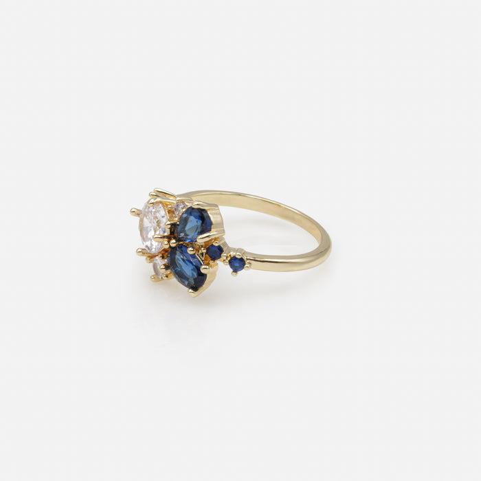 Bague dorée floraison de pierres marine et blanches