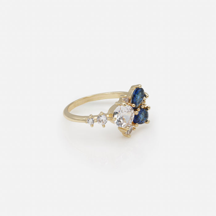 Bague dorée floraison de pierres marine et blanches