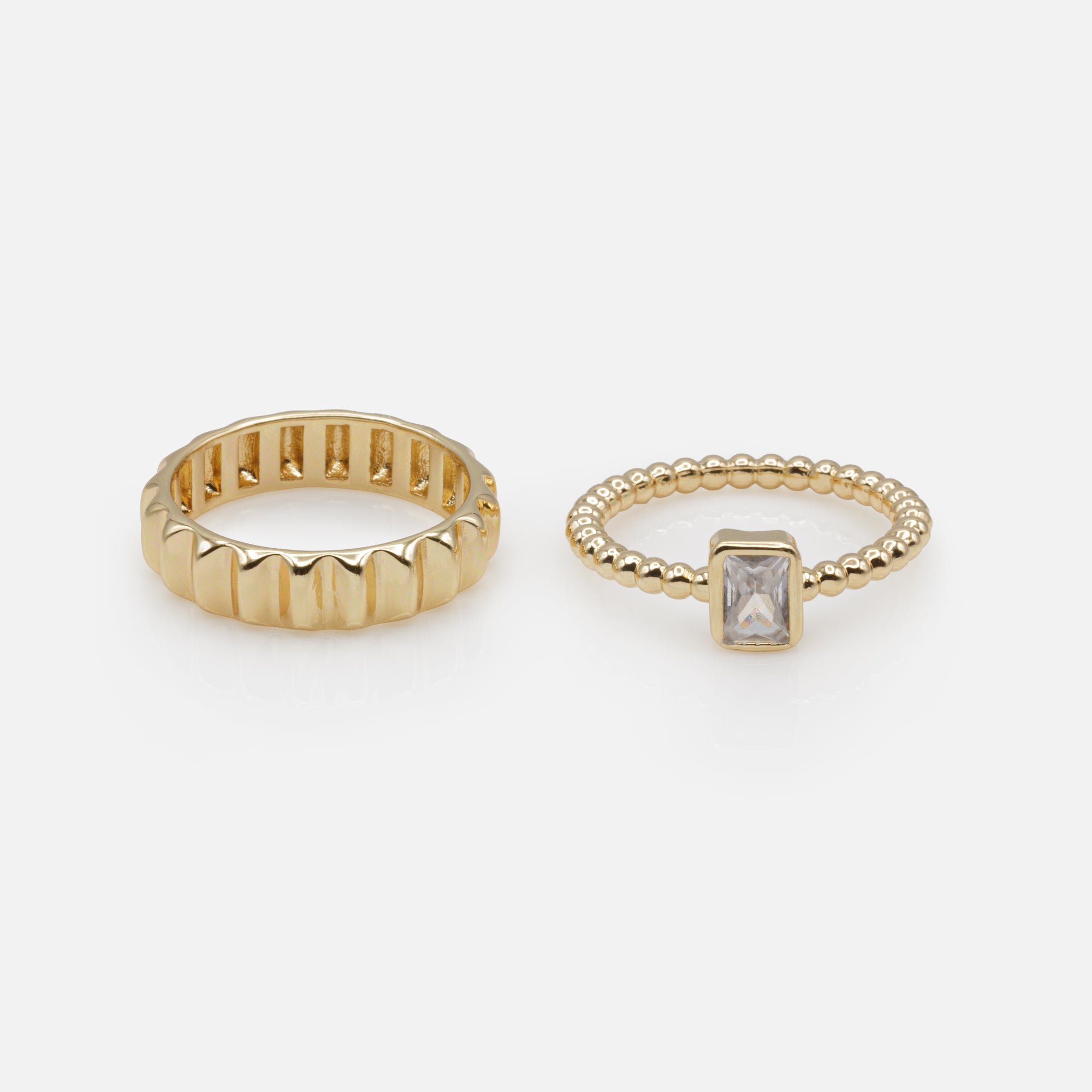 Duo of golden rings with rectangular stone and embossed ring