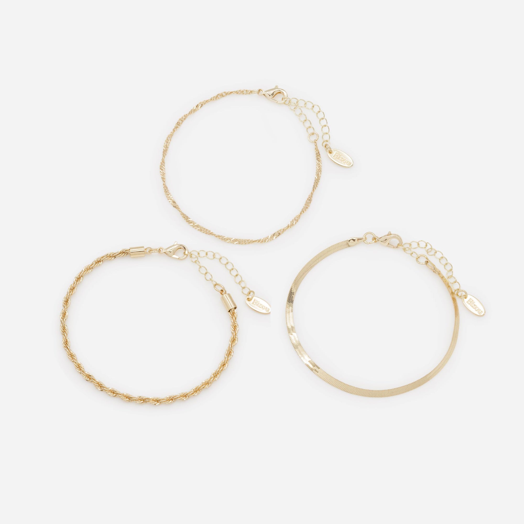 Trio of gold bracelets with flat and twisted links