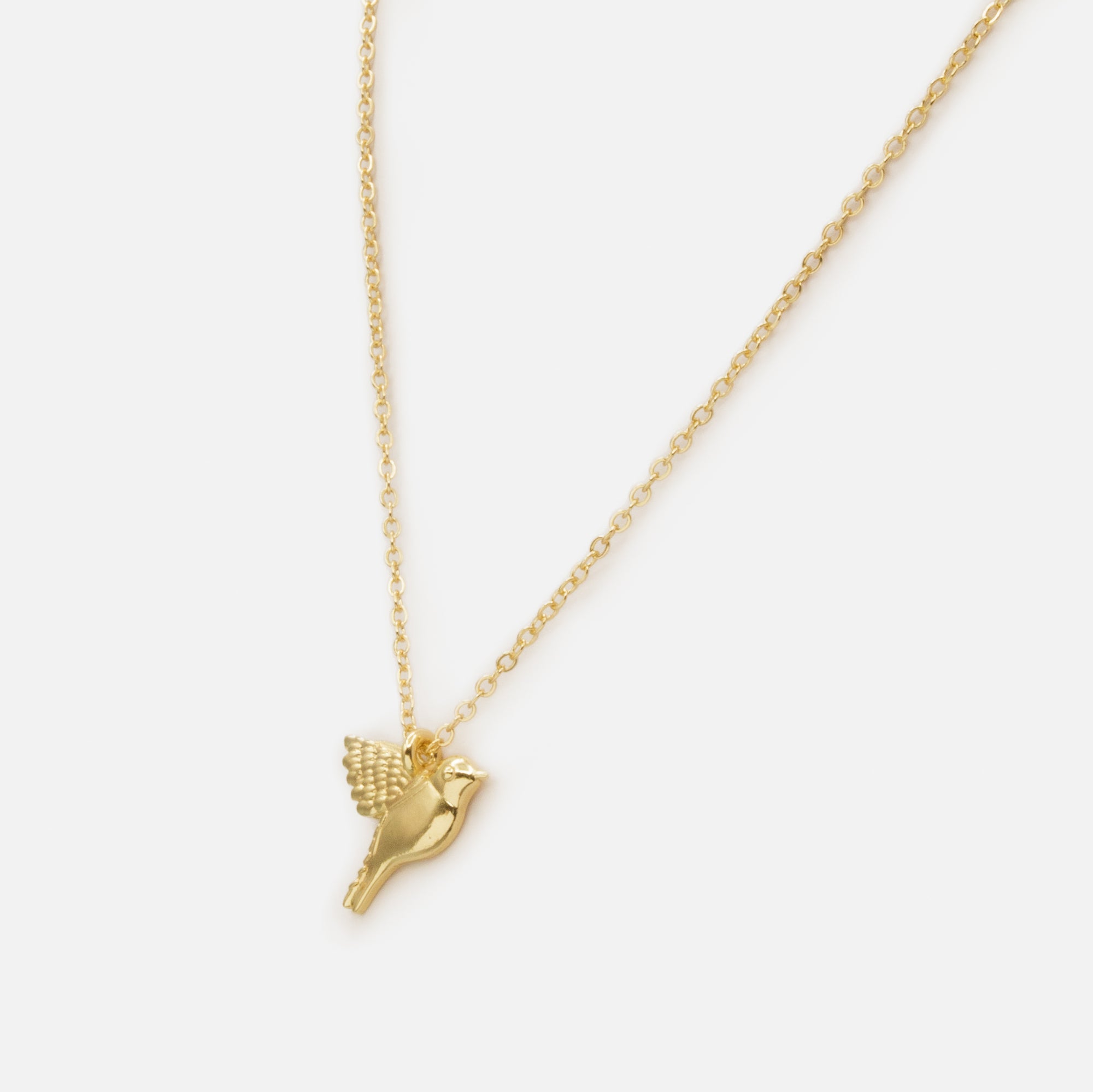 Collier doré avec breloque oiseau
