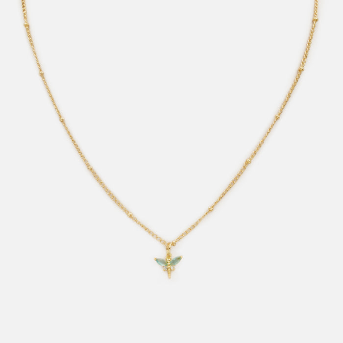 Collier doré avec breloque libellule aux ailes turquoise